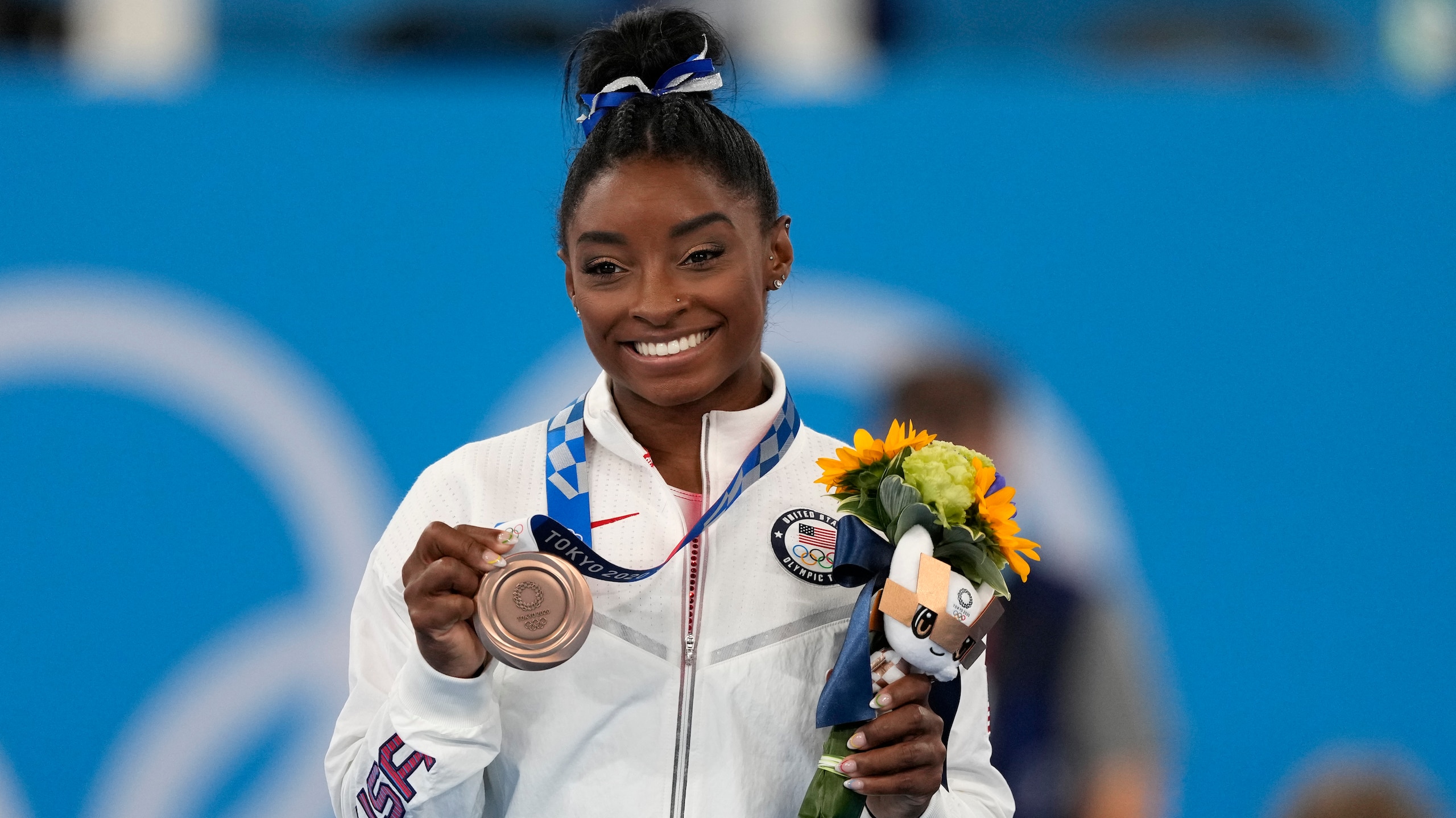 U.S. gymnast Simone Biles poses with her bronze medal for the artistic gymnastics women's balance beam apparatus at the 2020 Summer Olympics, Tuesday, Aug. 3, 2021, in Tokyo, Japan. (AP Photo/Jae C. Hong)