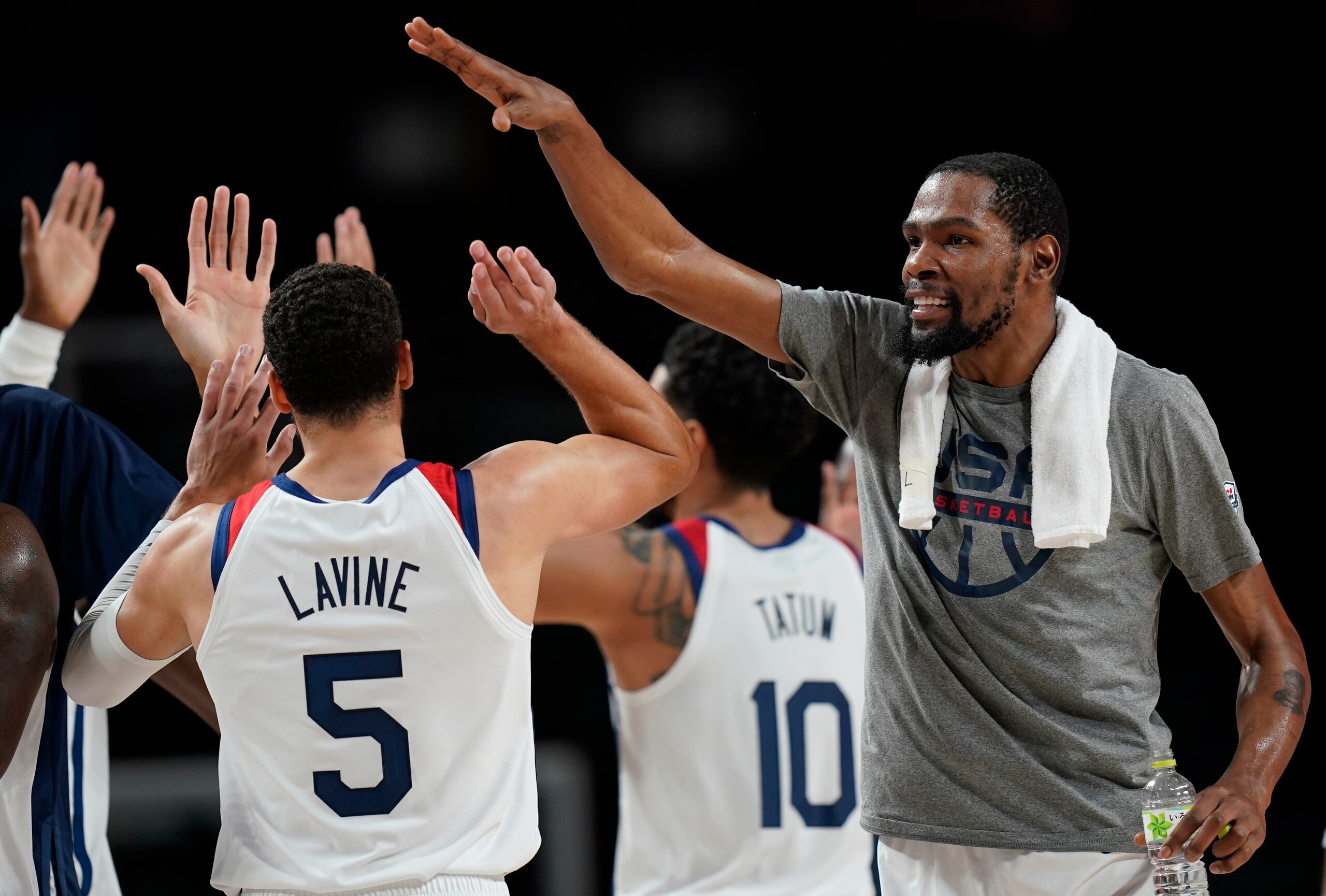 United States's Kevin Durant (7), right, celebrates with teammates during men's basketball semifinal game against Australia at the 2020 Summer Olympics, Thursday, Aug. 5, 2021, in Saitama, Japan. (AP Photo/Eric Gay)
