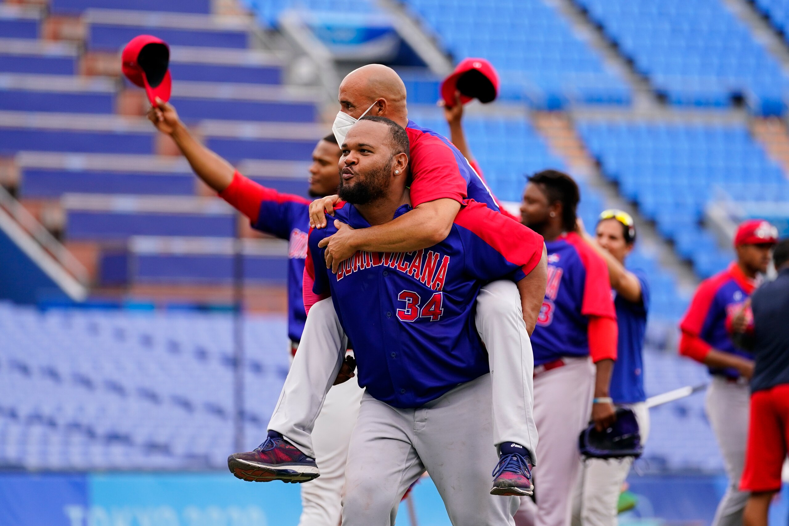 Dominican Republic's Juan Ramon Francisco Gonzalez, front and Raul Valdes, celebrate after the bronze medal baseball game against South Korea at the 2020 Summer Olympics, Saturday, Aug. 7, 2021, in Yokohama, Japan. The Dominican Republic won 10-6. (AP Photo/Matt Slocum)