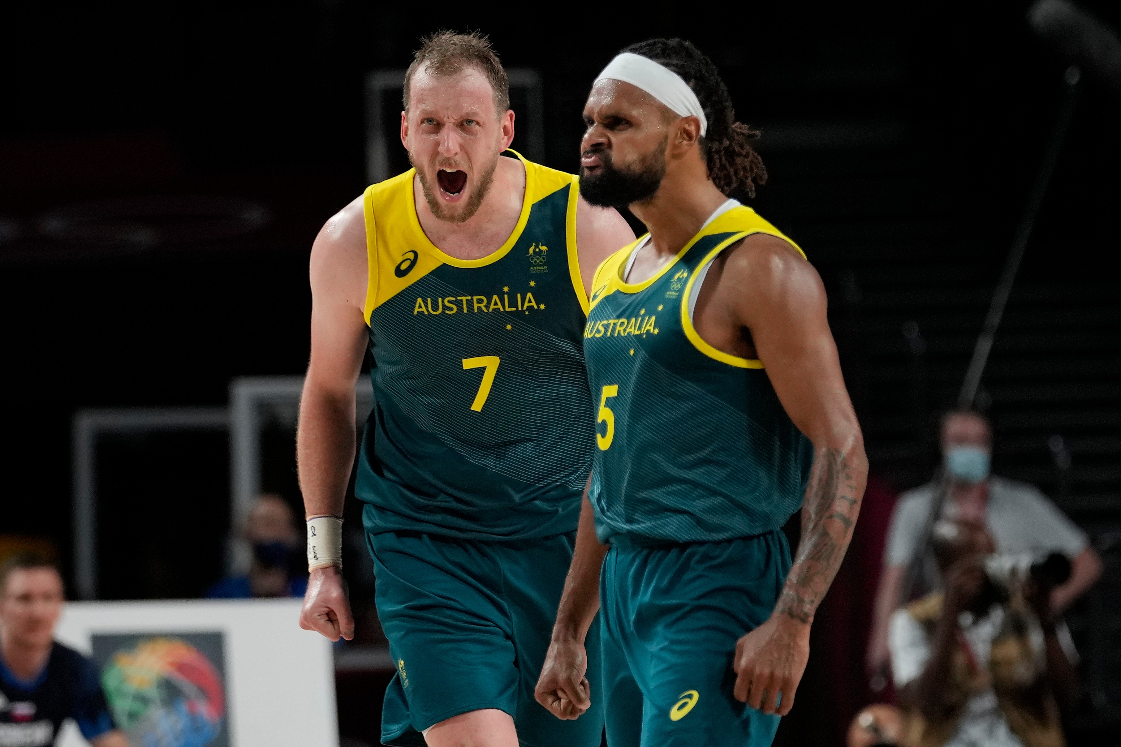 Australia's Joe Ingles (7) and Patty Mills (5) react to a score by Mills against Slovenia during the men's bronze medal basketball game at the 2020 Summer Olympics, Saturday, Aug. 7, 2021, in Tokyo, Japan. (AP Photo/Eric Gay)