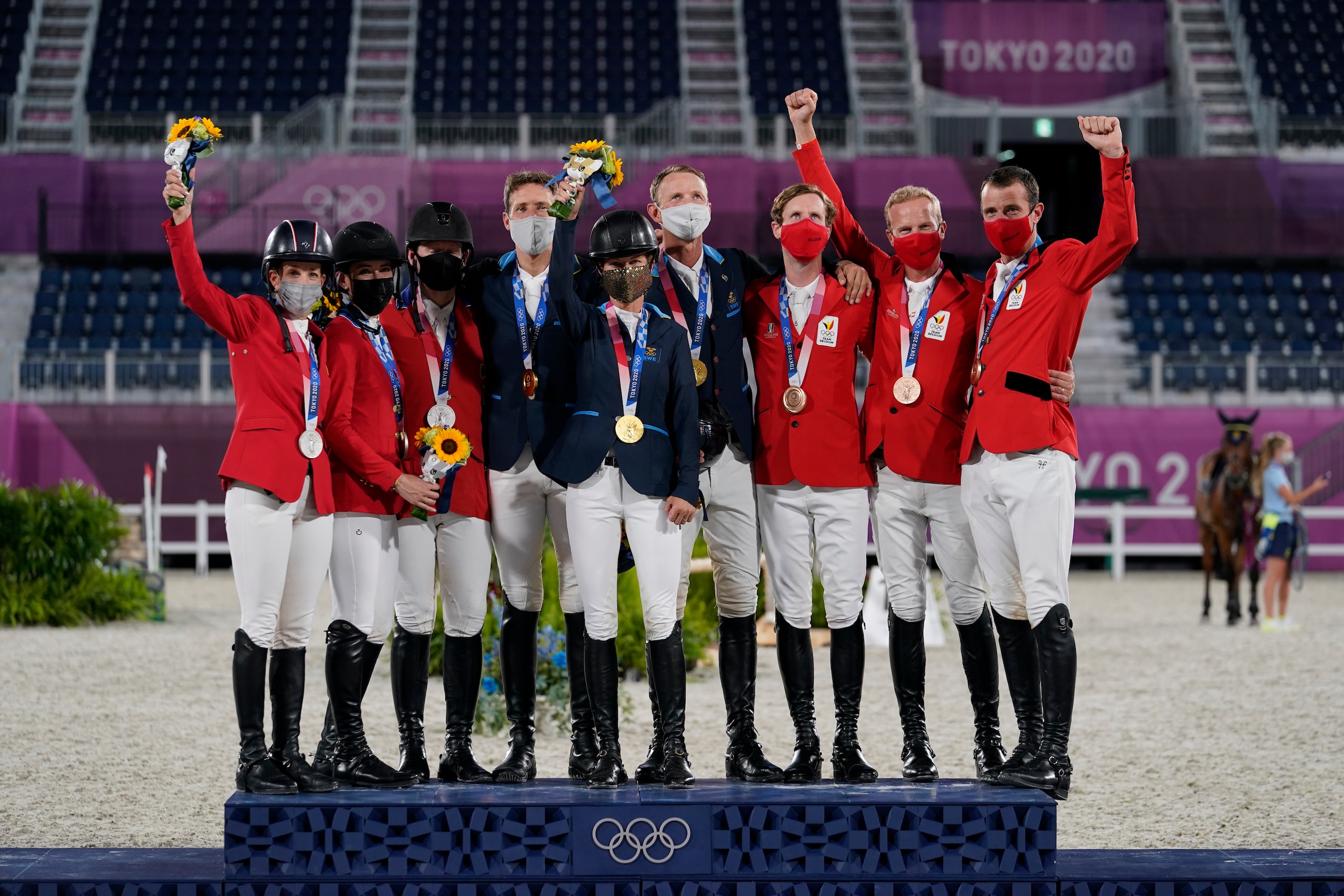 From left, silver medal winners United States' team of Laura Kraut, Jessica Springsteen and McLain Ward, gold medal winners Sweden's team of Henrik von Eckermann, Malin Baryard-Johnsson and Peder Fredricson, and bronze medal winners Belgium's Pieter Devos, Jerome Guery and Gregory Wathelet gather during a equestrian jumping team medal ceremony at the 2020 Summer Olympics, Saturday, Aug. 7, 2021, in Tokyo, Japan. (AP Photo/Carolyn Kaster)