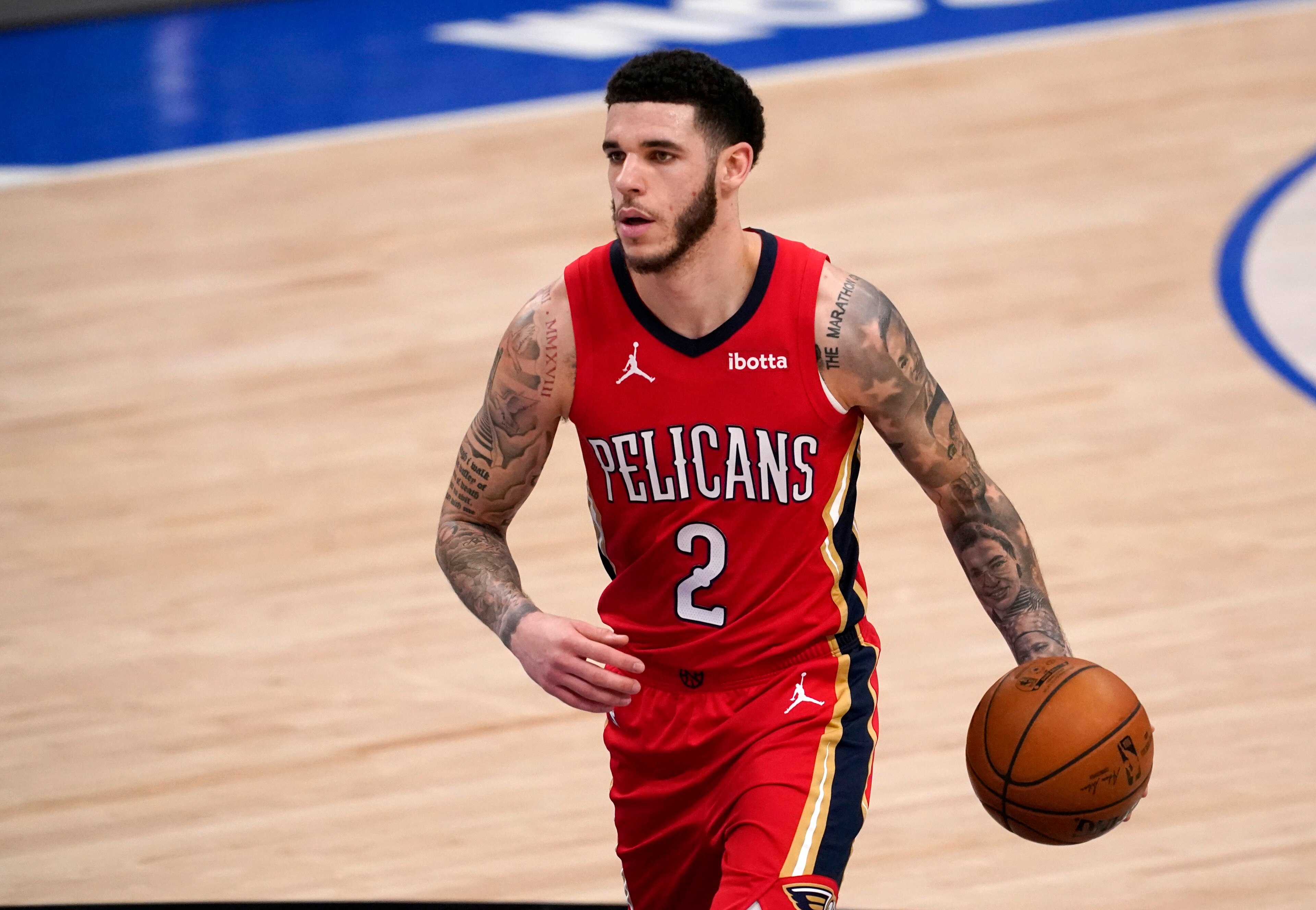 FILE - In this Feb. 12, 2021, file photo, New Orleans Pelicans' Lonzo Ball brings the ball up during the team's NBA basketball game against the Dallas Mavericks in Dallas. A person familar with the situation says Ball is heading to Chicago in a sign-and-trade agreement that will also send Bulls guards Tomas Satoransky and Garrett Temple III to the Pelicans. The person spoke to The Associated Press on condition of anonymity Monday, Aug. 2, because trades cannot becoming official until Friday under NBA rules. (AP Photo/Tony Gutierrez, File)