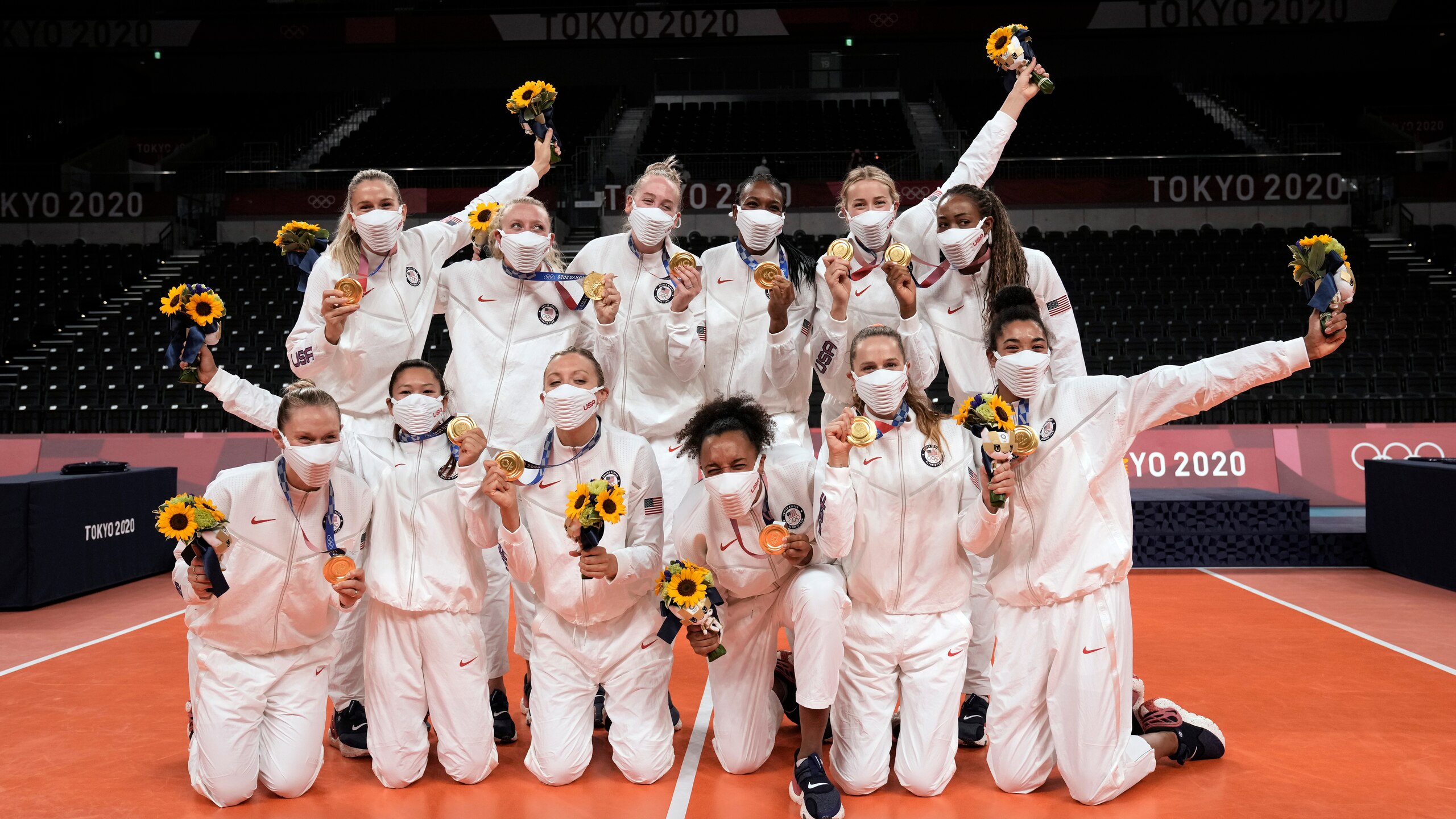 Players from the United States pose after winning the gold medal in women's volleyball at the 2020 Summer Olympics, Sunday, Aug. 8, 2021, in Tokyo, Japan. (AP Photo/Manu Fernandez)