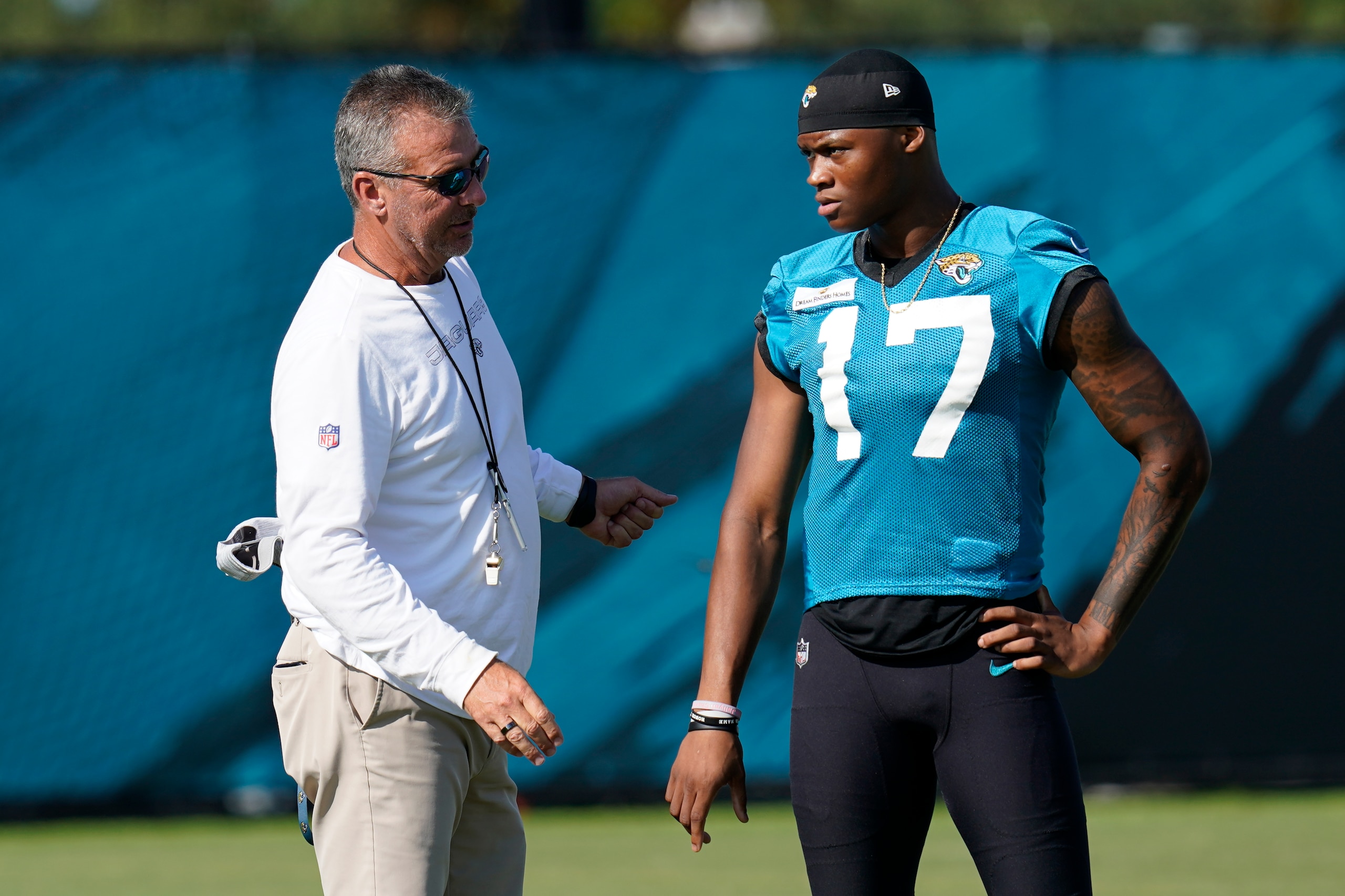 Jacksonville Jaguars head coach Urban Meyer, left, talks with wide receiver D.J. Chark (17) during NFL football practice, Saturday, July 31, 2021, in Jacksonville, Fla. (AP Photo/John Raoux) Jacksonville Jaguars head coach Urban Meyer, left, talks with wide receiver D.J. Chark (17) during NFL football practice, Saturday, July 31, 2021, in Jacksonville, Fla. (AP Photo/John Raoux)