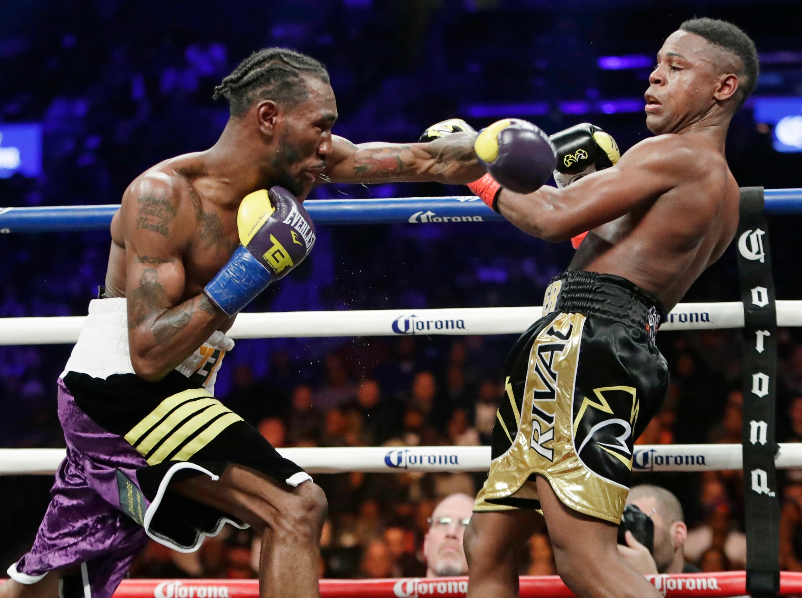 Robert Easter Jr., left, throws a left at Javier Fortuna during the ninth round of an IBF lightweight championship boxing match Saturday, Jan. 20, 2018, in New York. Easter won the fight. (AP Photo/Frank Franklin II)