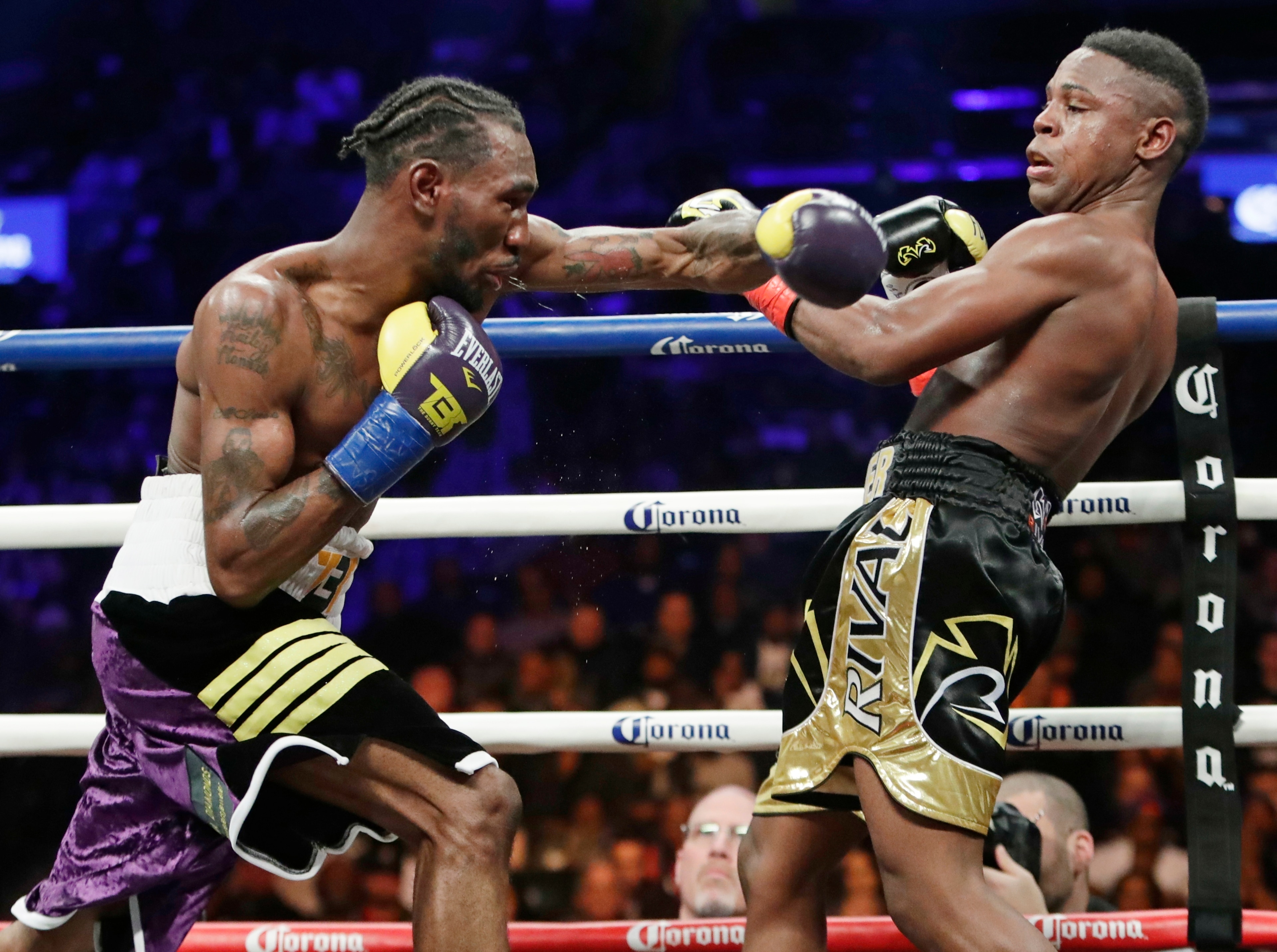 Robert Easter Jr., left, throws a left at Javier Fortuna during the ninth round of an IBF lightweight championship boxing match Saturday, Jan. 20, 2018, in New York. Easter won the fight. (AP Photo/Frank Franklin II)