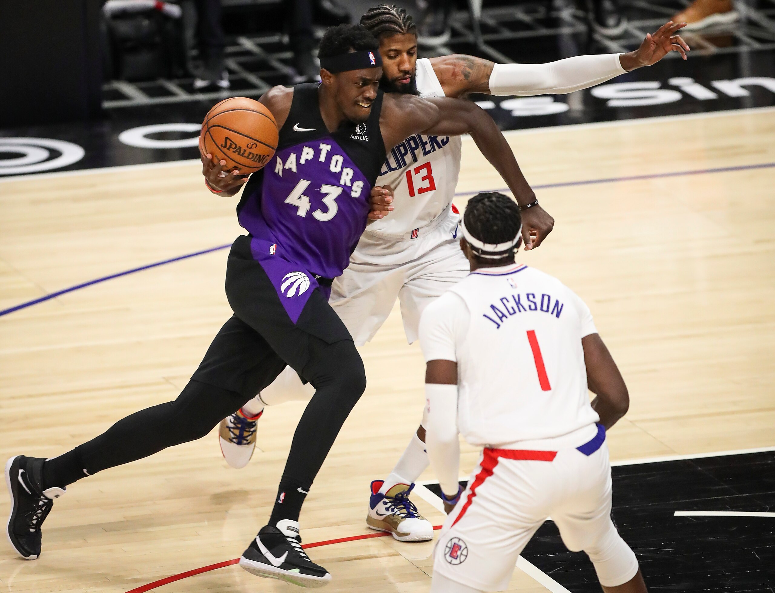LOS ANGELES, CALIFORNIA - MAY 04: Pascal Siakam #43 of the Toronto Raptors handles the ball defended by Paul George #13 of the LA Clippers at Staples Center on May 04, 2021 in Los Angeles, California. NOTE TO USER: User expressly acknowledges and agrees that, by downloading and or using this photograph, User is consenting to the terms and conditions of the Getty Images License Agreement. (Photo by Meg Oliphant/Getty Images)