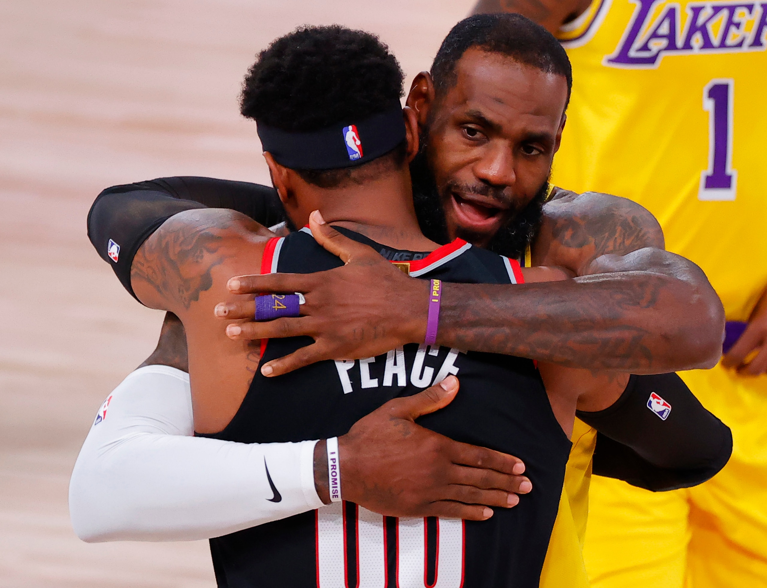 LAKE BUENA VISTA, FLORIDA - AUGUST 29: LeBron James #23 of the Los Angeles Lakers and Carmelo Anthony #00 of the Portland Trail Blazers hug before the start of Game Five of the Western Conference First Round during the 2020 NBA Playoffs at AdventHealth Arena at ESPN Wide World Of Sports Complex on August 29, 2020 in Lake Buena Vista, Florida. NOTE TO USER: User expressly acknowledges and agrees that, by downloading and or using this photograph, User is consenting to the terms and conditions of the Getty Images License Agreement. (Photo by Kevin C. Cox/Getty Images)
