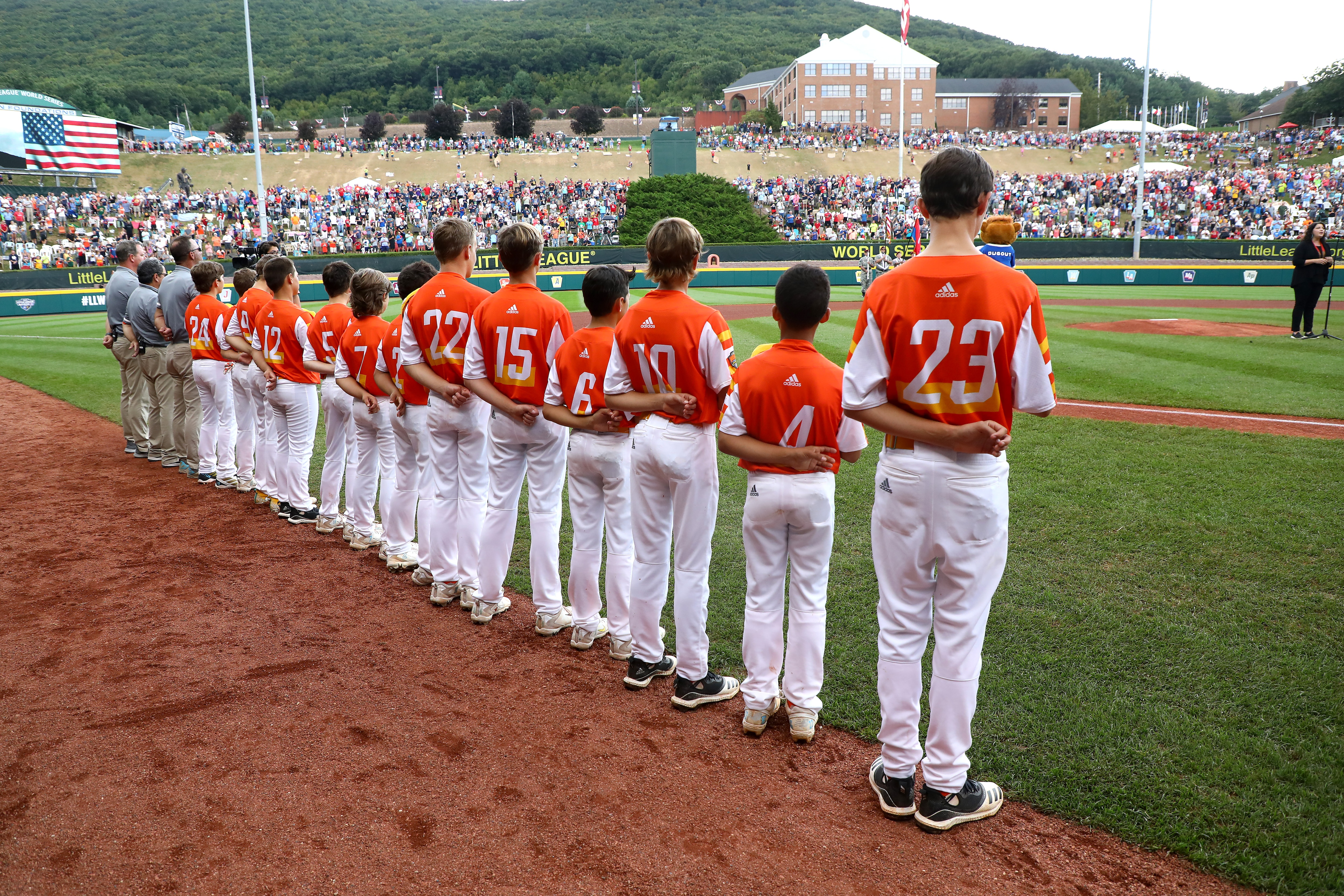SOUTH WILLIAMSPORT, PENNSYLVANIA - AUGUST 25: Members of the Southwest Region team from River Ridge Louisiana listen to the national anthem before the start of their game against the Caribbean Region team from Willemstad, Curacao during the Championship Game of the Little League World Series at Lamade Stadium on August 25, 2019 in South Williamsport, Pennsylvania. (Photo by Rob Carr/Getty Images)