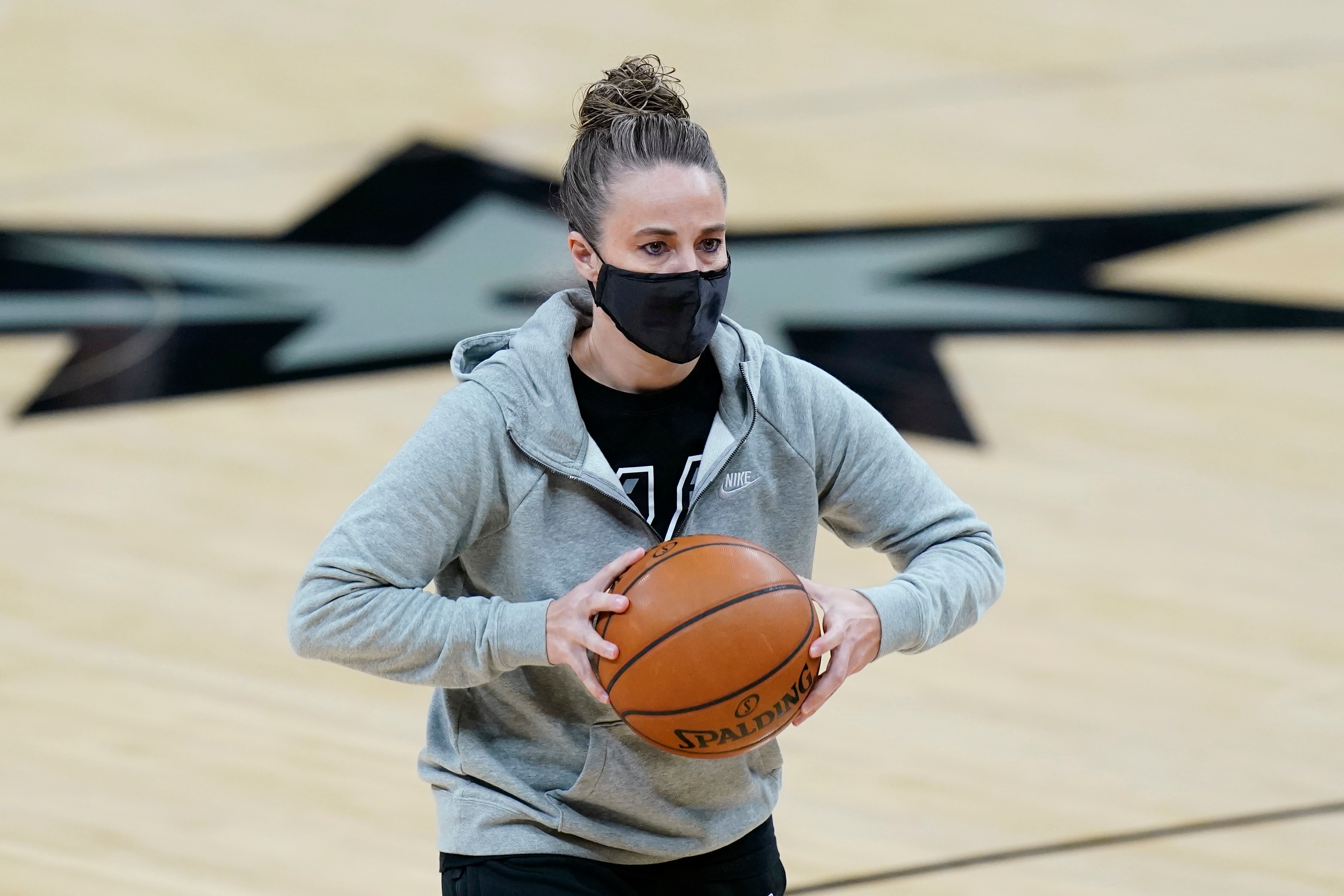 San Antonio Spurs assistant coach Becky Hammon works with players before an NBA basketball game against the Denver Nuggets in San Antonio, Friday, Jan. 29, 2021. (AP Photo/Eric Gay)