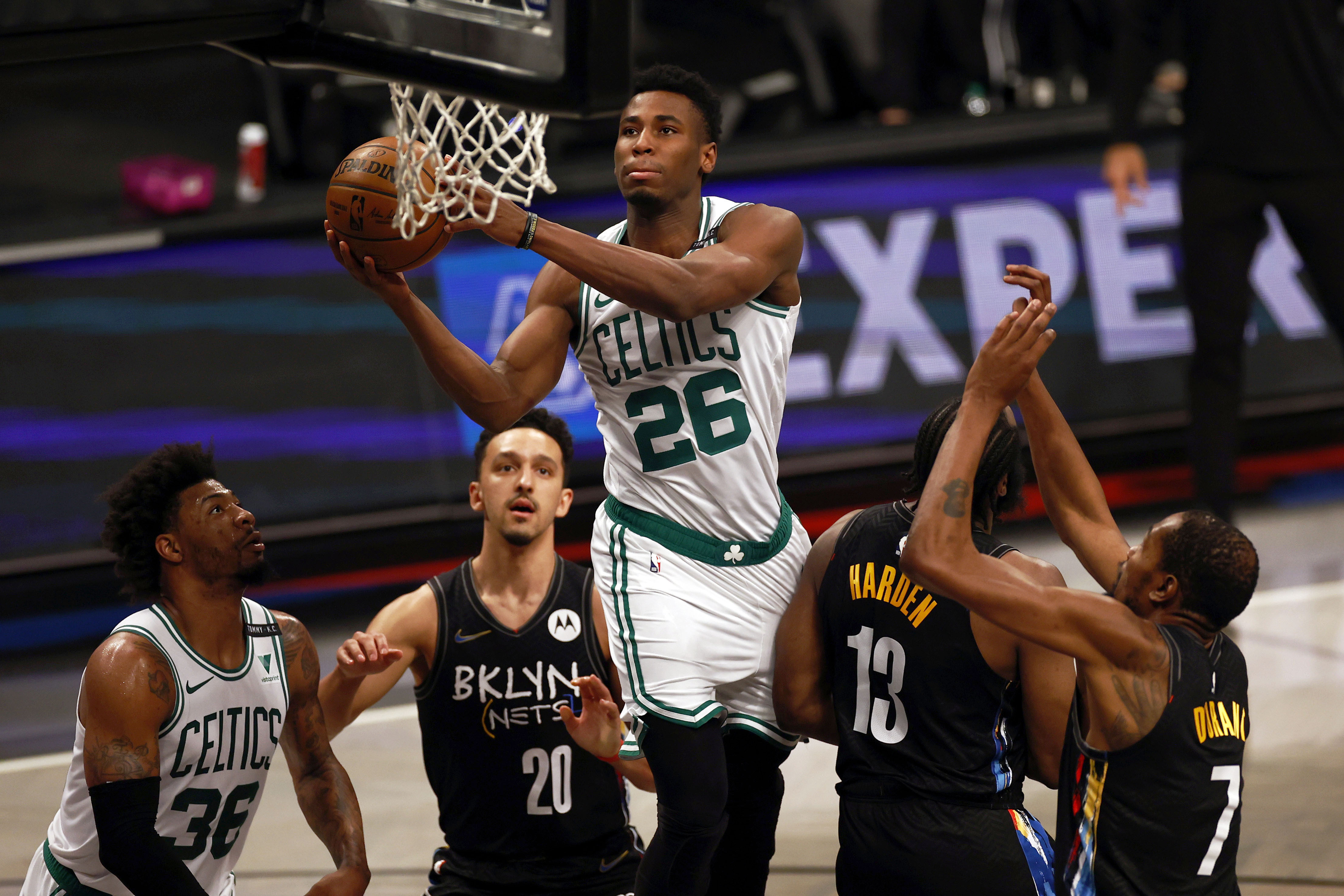 Boston Celtics forward Aaron Nesmith (26) drives to the basket past Brooklyn Nets guard James Harden (13) in the first half of Game 5 during an NBA basketball first-round playoff series, Tuesday, June 1, 2021, in New York. (AP Photo/Adam Hunger)