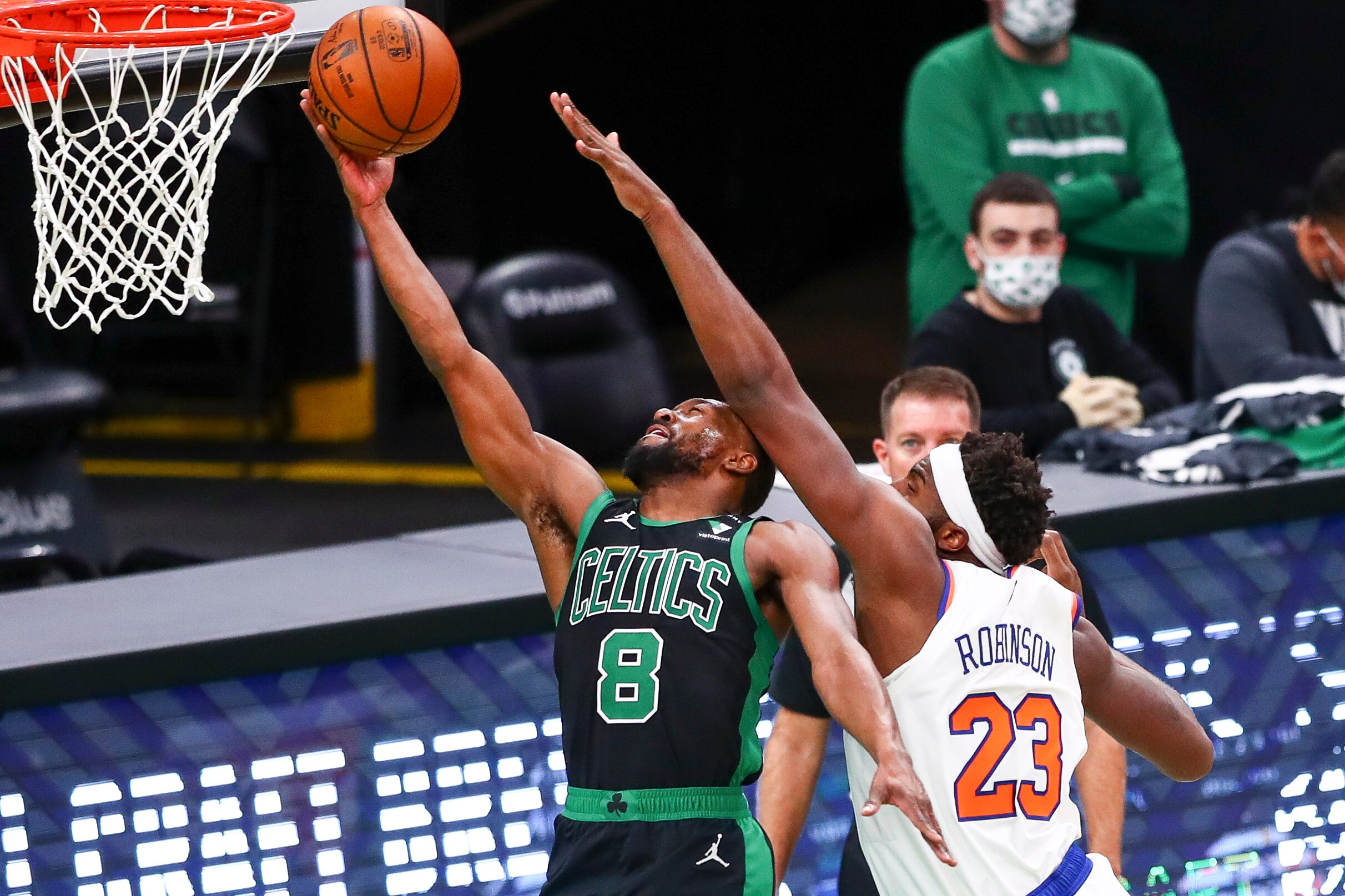 BOSTON, MA - JANUARY 17:  Kemba Walker #8 of the Boston Celtics is fouled by Mitchell Robinson #23 of the New York Knicks as he dives to the basket and scores during a game at TD Garden on January 17, 2021 in Boston, Massachusetts. NOTE TO USER: User expressly acknowledges and agrees that, by downloading and or using this photograph, User is consenting to the terms and conditions of the Getty Images License Agreement. (Photo by Adam Glanzman/Getty Images)