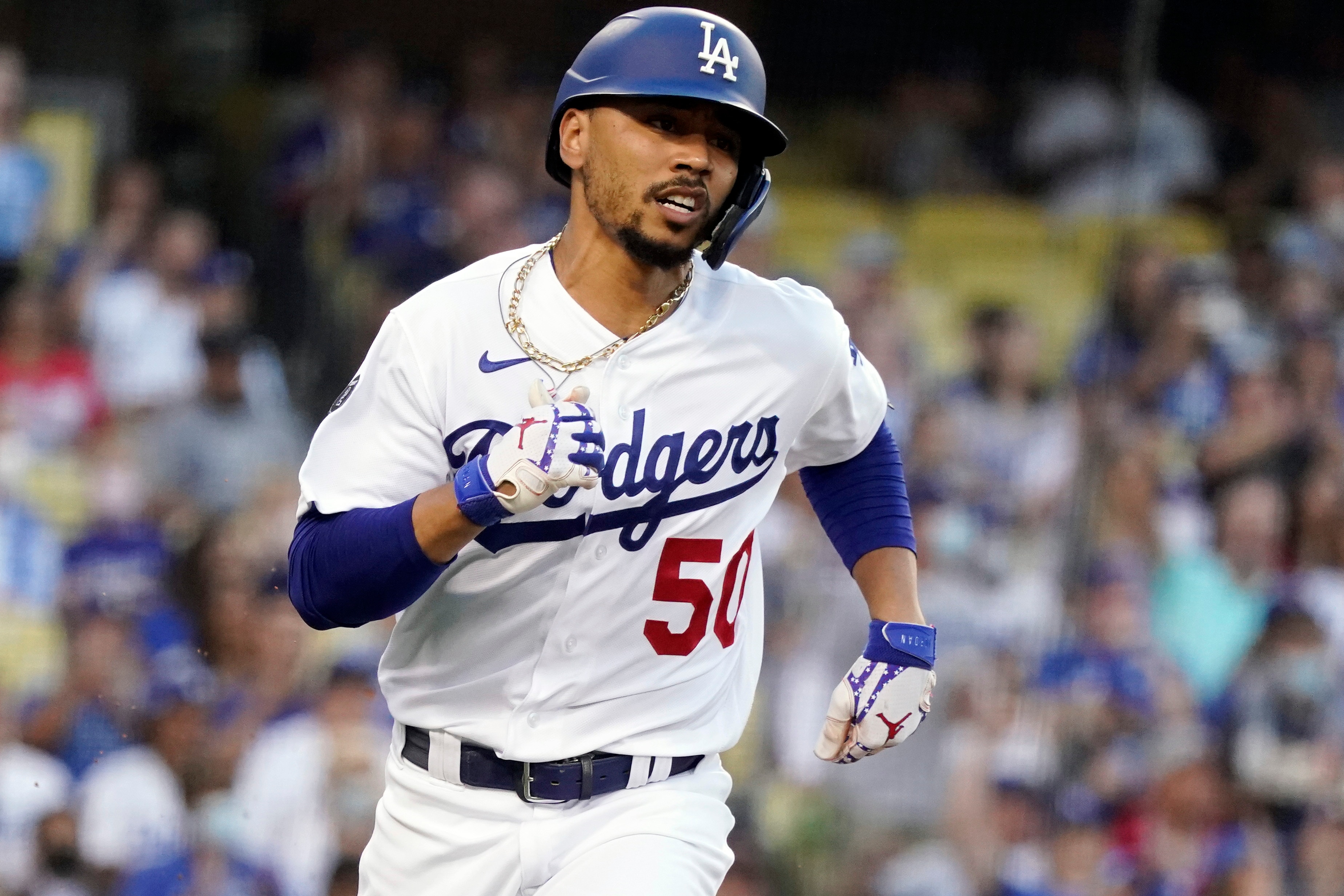 Los Angeles Dodgers' Mookie Betts runs to first on a single during the first inning of the team's baseball game against the Los Angeles Angels on Friday, Aug. 6, 2021, in Los Angeles. (AP Photo/Marcio Jose Sanchez)