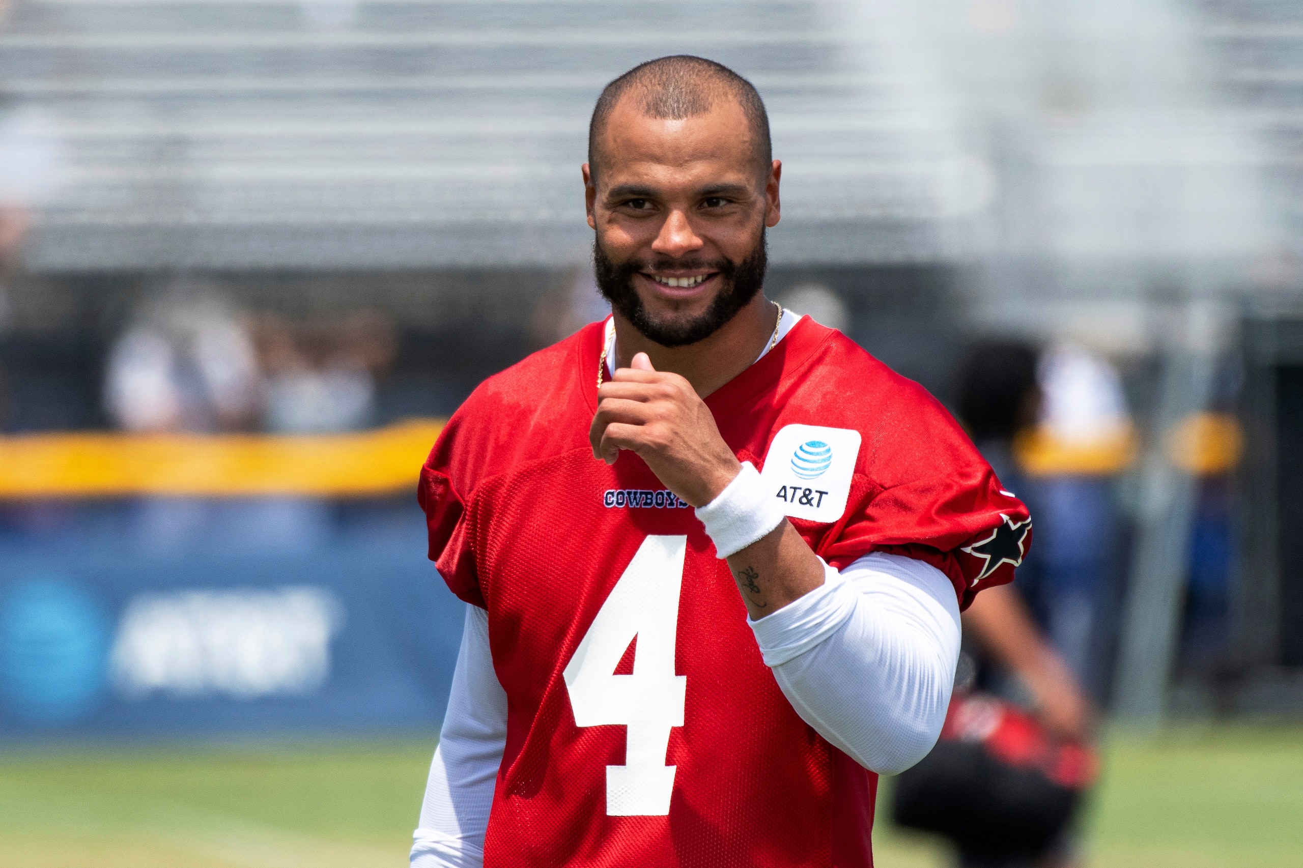 Dallas Cowboys quarterback Dak Prescott smiles following practice at the NFL football team's training camp in Oxnard, Calif., Thursday, July 22, 2021. (AP Photo/Michael Owen Baker)
