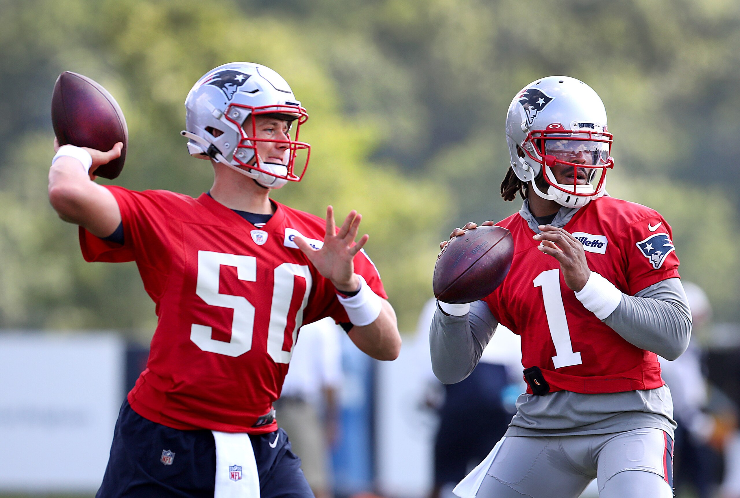 Foxborough, MA - July 30: Quarterbacks Mac Jones, left, and Cam Newton fire passes during a drill. The New England Patriots holdDay 3 of training camp at the Gillette Stadium practice field in Foxborough, MA on July 30, 2021. (Photo by John Tlumacki/The Boston Globe via Getty Images) Foxborough, MA - July 30: Quarterbacks Mac Jones, left, and Cam Newton fire passes during a drill. The New England Patriots holdDay 3 of training camp at the Gillette Stadium practice field in Foxborough, MA on July 30, 2021. (Photo by John Tlumacki/The Boston Globe via Getty Images)