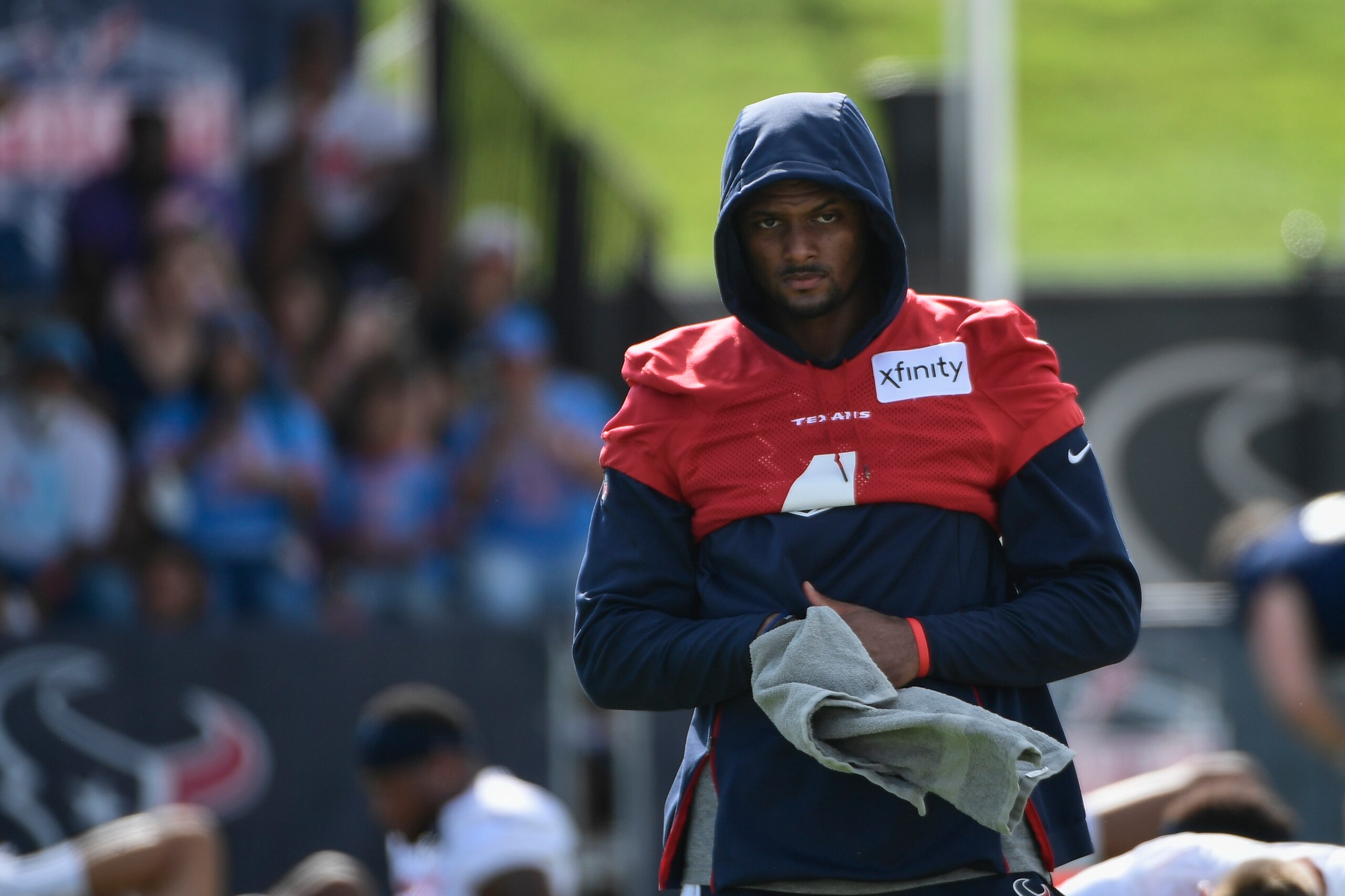 Texans quarterback Deshaun Watson (4) wipes his hands after stretching during NFL football practice Saturday, July 31, 2021, in Houston. (AP Photo/Justin Rex)