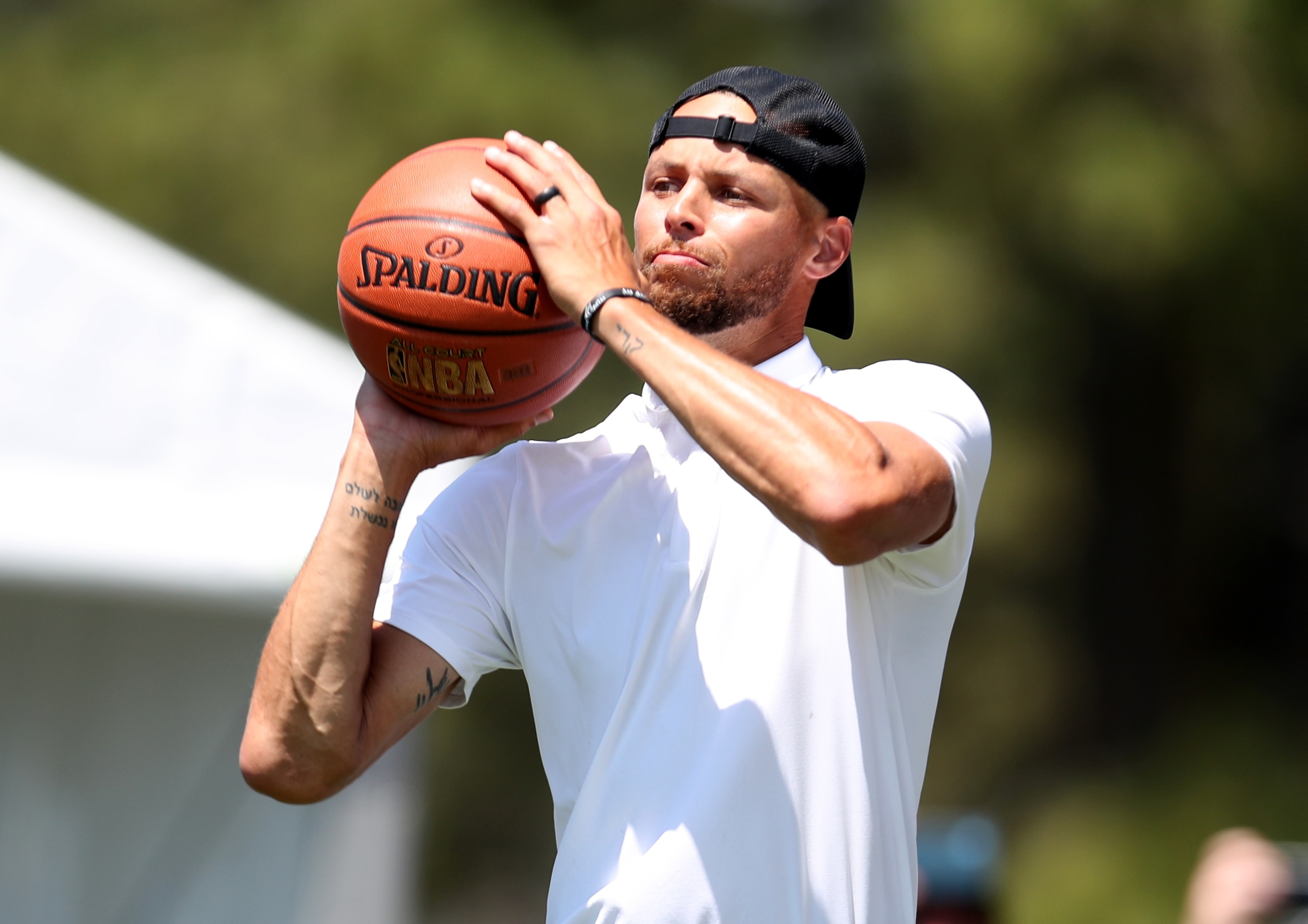 SOUTH LAKE TAHOE, NEVADA - JULY 10: NBA athlete Steph Curry shoots a basketball  on the 17th hole during round two of the American Century Championship at Edgewood Tahoe South golf course on July 10, 2020 in South Lake Tahoe, Nevada.  (Photo by Jed Jacobsohn/Getty Images)