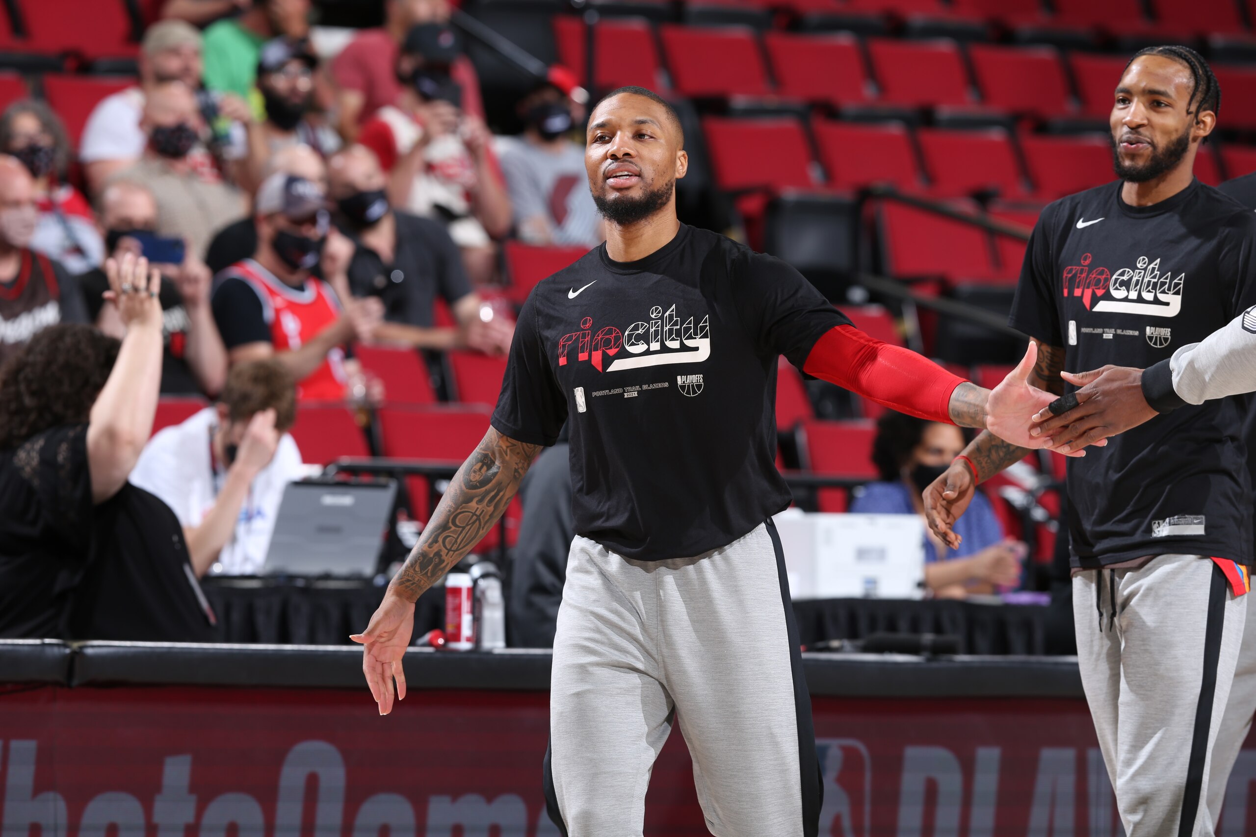 PORTLAND, OR - JUNE 3: Damian Lillard #0 of the Portland Trail Blazers high fives his teammate before the game against the Denver Nuggets on June 3, 2021 at the Moda Center Arena in Portland, Oregon. NOTE TO USER: User expressly acknowledges and agrees that, by downloading and or using this photograph, user is consenting to the terms and conditions of the Getty Images License Agreement. Mandatory Copyright Notice: Copyright 2021 NBAE (Photo by Sam Forencich/NBAE via Getty Images)