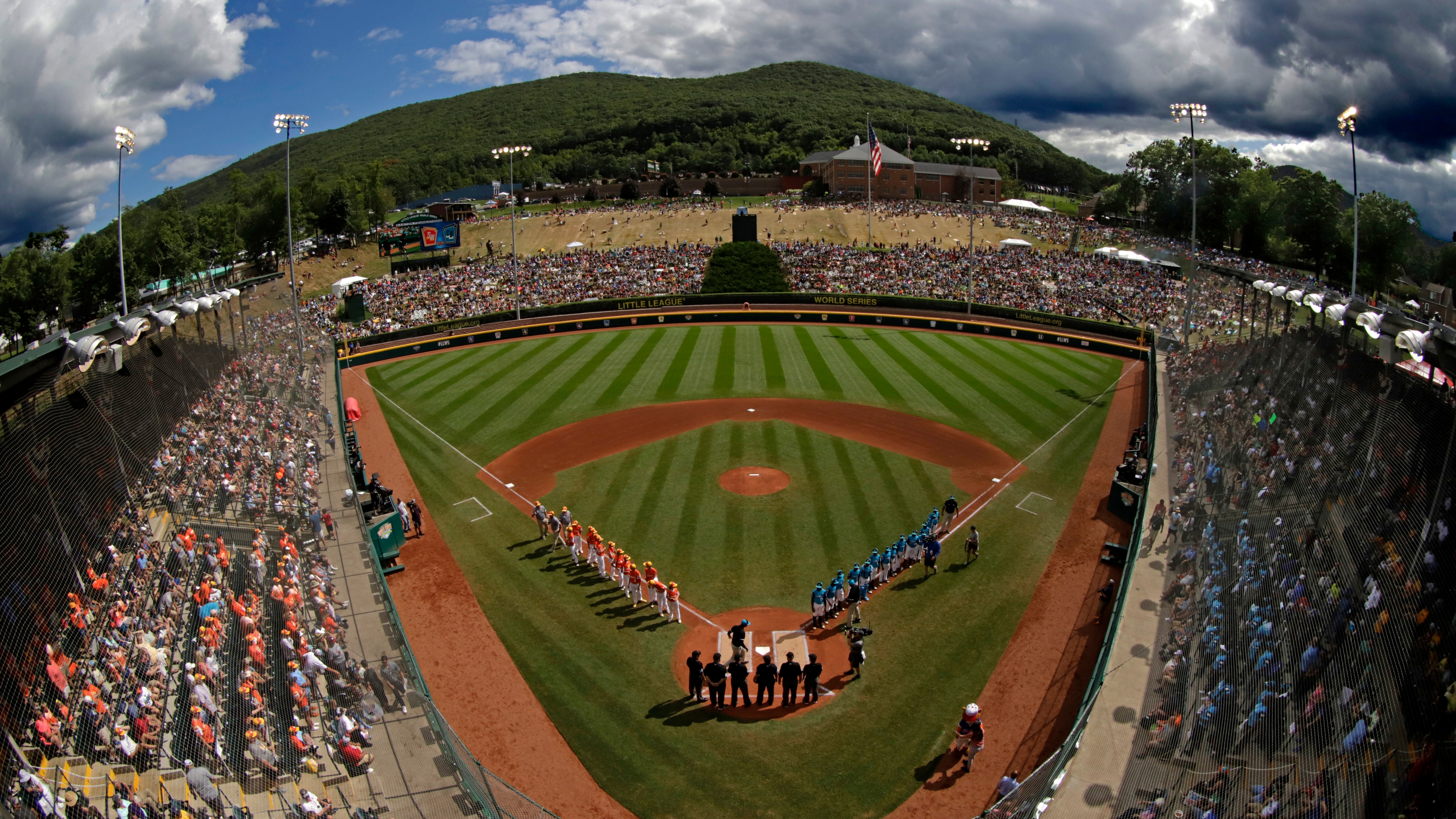 FILE - In this Sunday, Aug. 25, 2019, file photo, River Ridge, Louisiana, lines the third baseline and Curacao lines the first baseline during team introductions before the Little League World Series Championship game at Lamade Stadium in South Williamsport, Pa. The 2020 Little League World Series and the championship tournaments in six other Little League divisions have been canceled because of the new coronavirus pandemic. (AP Photo/Gene J. Puskar, File)