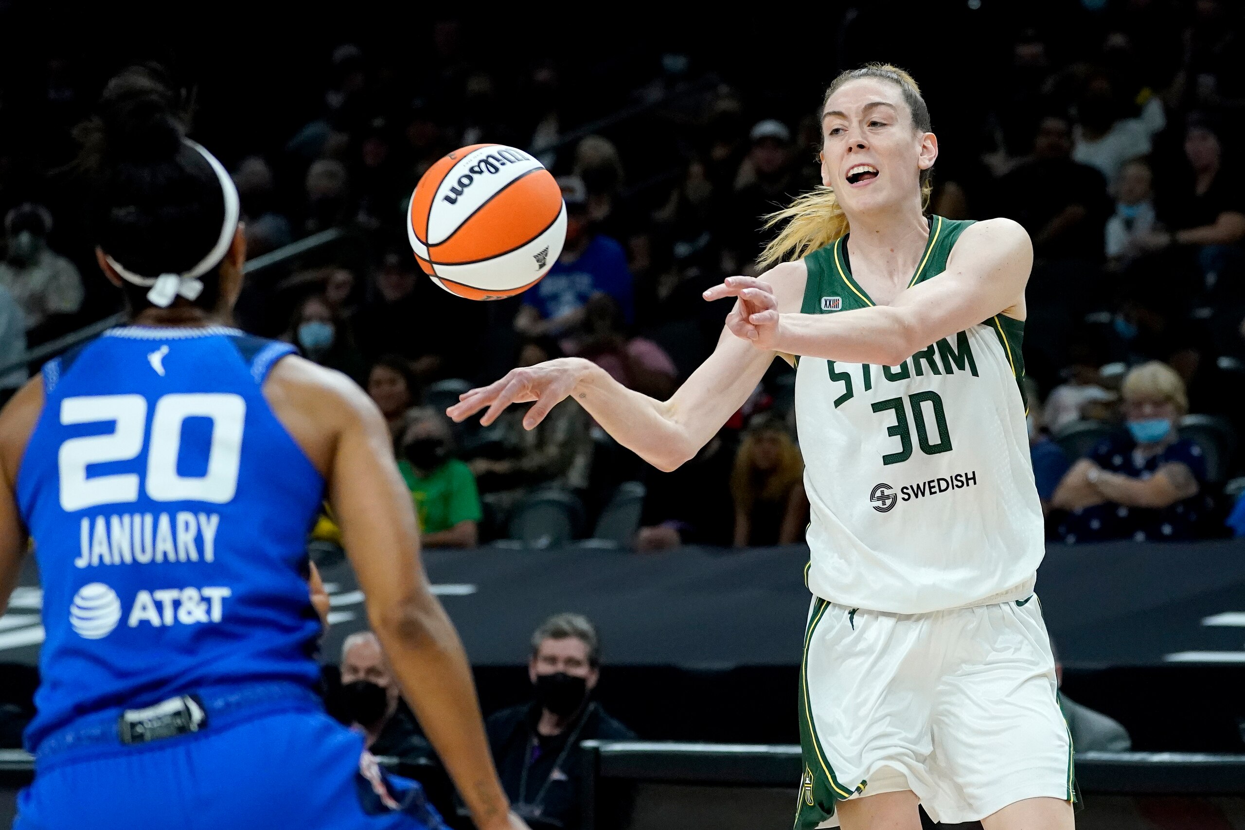 Seattle Storm forward Breanna Stewart (30) passes the ball as Connecticut Sun guard Briann January (20) defends during the first half of the Commissioner's Cup WNBA basketball game, Thursday, Aug. 12, 2021, in Phoenix. (AP Photo/Matt York)