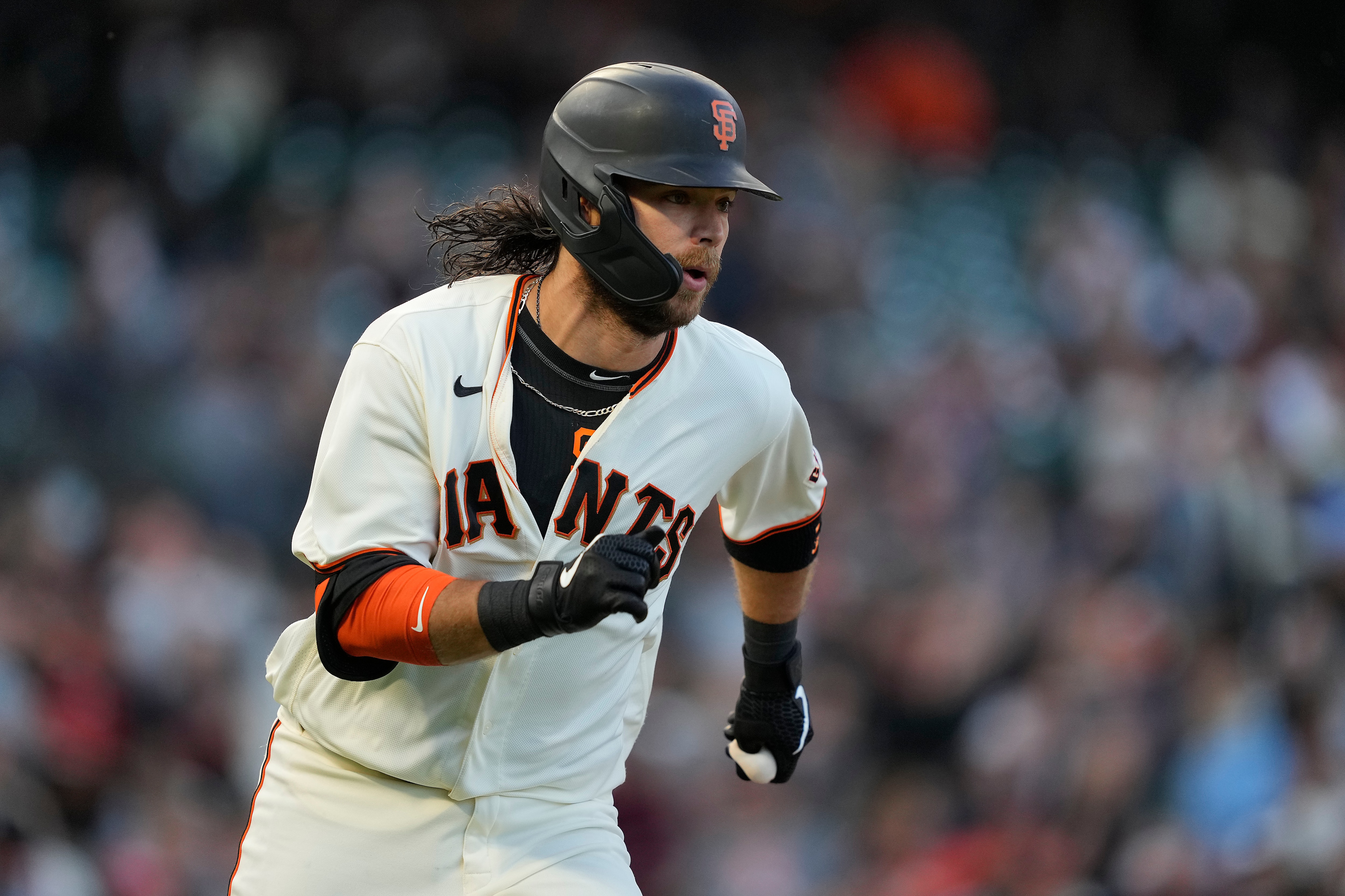 San Francisco Giants' Brandon Crawford (35) runs to first base after hitting a single against the Arizona Diamondbacks during the third inning of a baseball game Wednesday, Aug. 11, 2021, in San Francisco. (AP Photo/Tony Avelar)