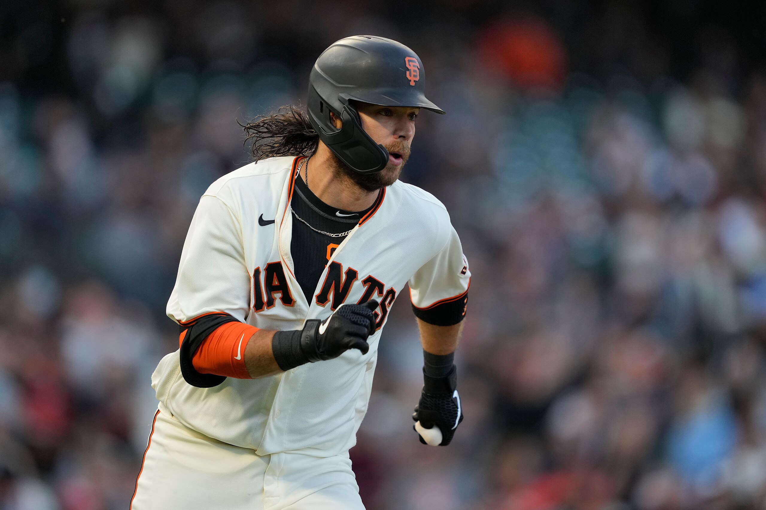 San Francisco Giants' Brandon Crawford (35) runs to first base after hitting a single against the Arizona Diamondbacks during the third inning of a baseball game Wednesday, Aug. 11, 2021, in San Francisco. (AP Photo/Tony Avelar)