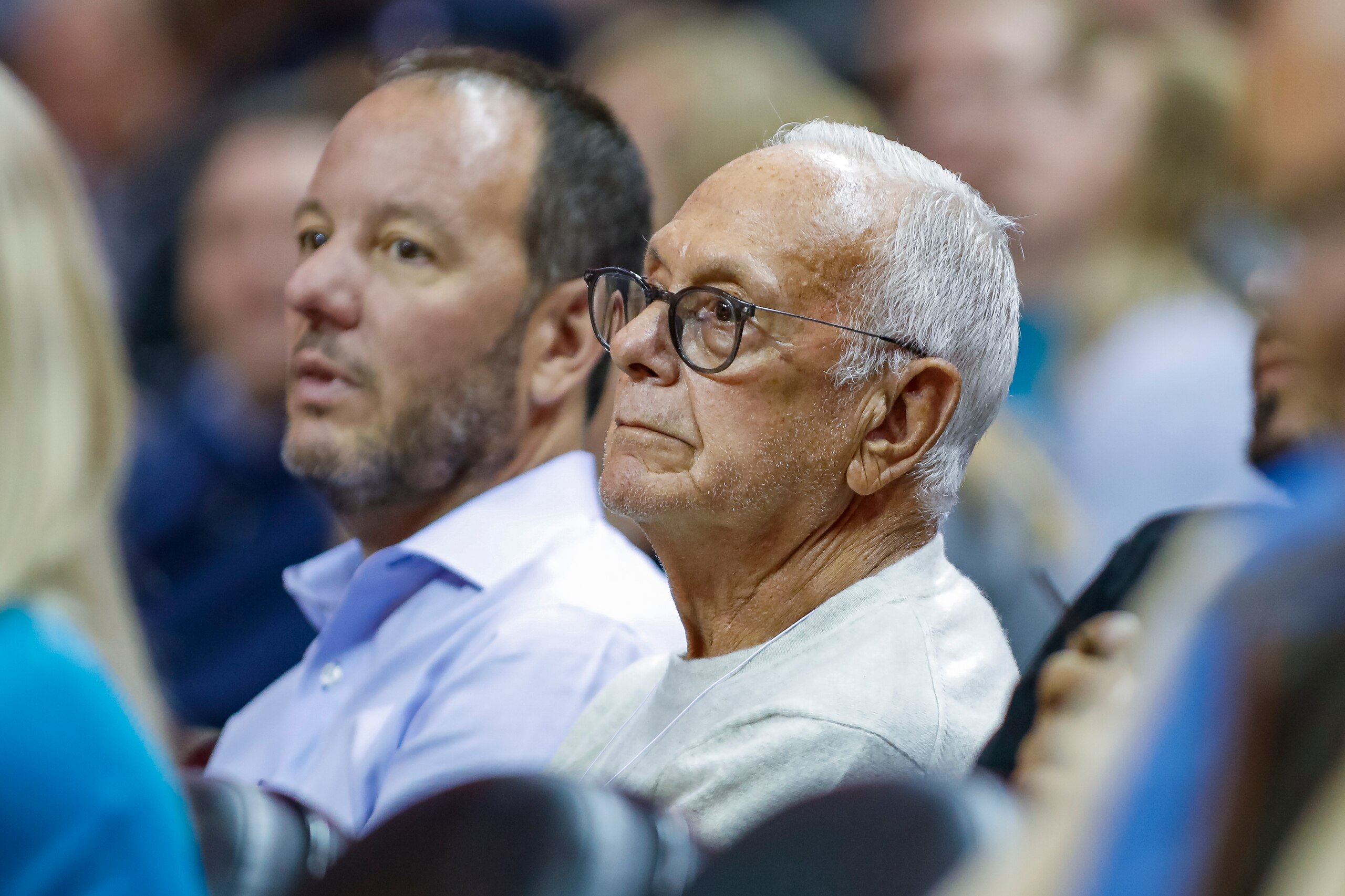 Former Charlotte Bobcats' head basketball coach Larry Brown sits court side and watches the Boston Celtics play the Charlotte Hornets during the second half of an NBA basketball game in Charlotte, N.C., Thursday, Nov. 7, 2019. The Celtics won 108-87. (AP Photo/Bob Leverone)