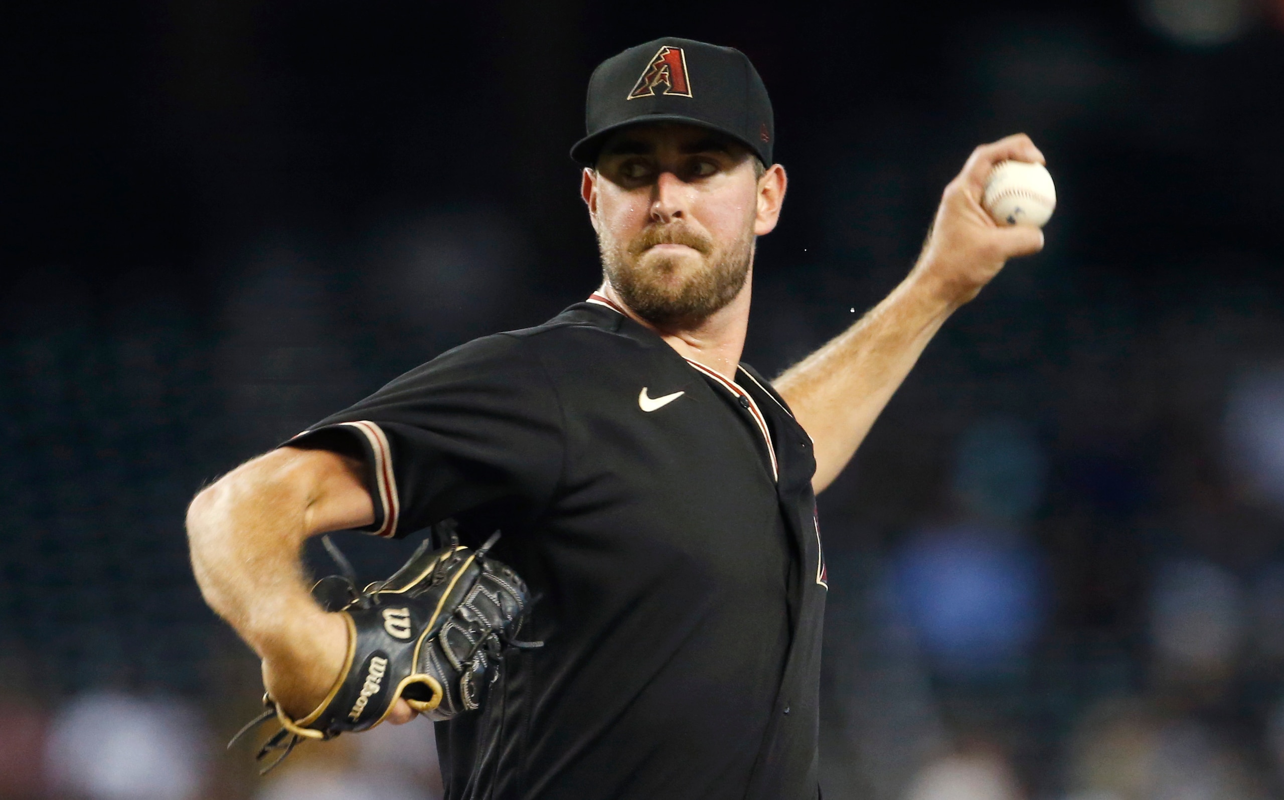 PHOENIX, ARIZONA - AUGUST 14: Starting pitcher Tyler Gilbert #49 of the Arizona Diamondbacks throws against the San Diego Padres during the first inning of the MLB game at Chase Field on August 14, 2021 in Phoenix, Arizona. (Photo by Ralph Freso/Getty Images)