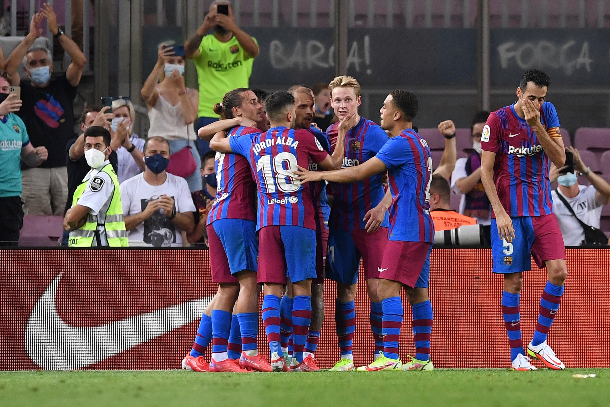 BARCELONA, SPAIN - AUGUST 15: Martin Braithwaite of FC Barcelona celebrates with team mates after scoring their side's second goal during the LaLiga Santander match between FC Barcelona and Real Sociedad at Camp Nou on August 15, 2021 in Barcelona, Spain. FC Barcelona will host between 20,000 and 22,0000 fans in the stadium as the Regional government has authorised a capacity of 30 percent with the requirement to maintain a meter and a half distance between people or groups of people who have tickets. (Photo by Alex Caparros/Getty Images)
