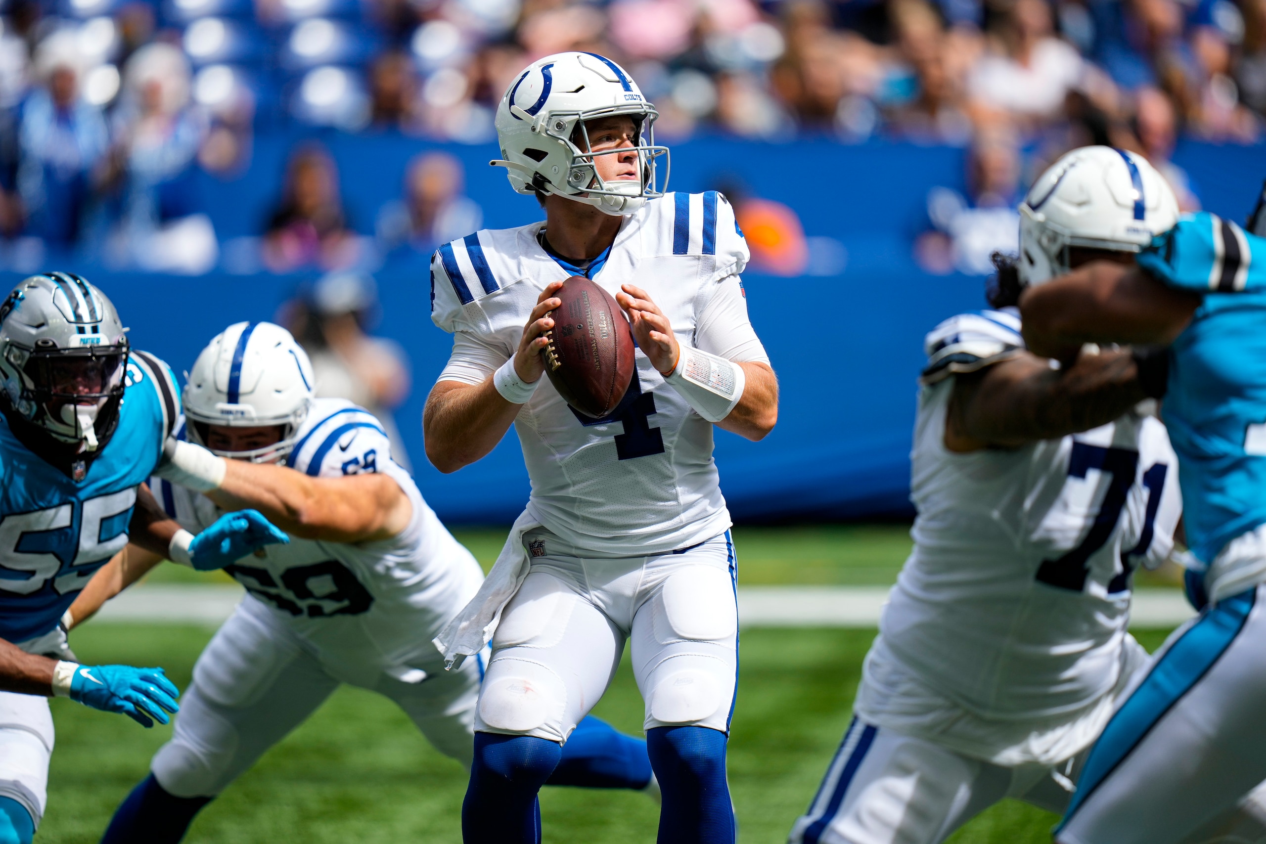 Indianapolis Colts quarterback Sam Ehlinger (4) plays against the Carolina Panthers during the second half of an NFL football game in Indianapolis, Sunday, Aug. 15, 2021. (AP Photo/AJ Mast)