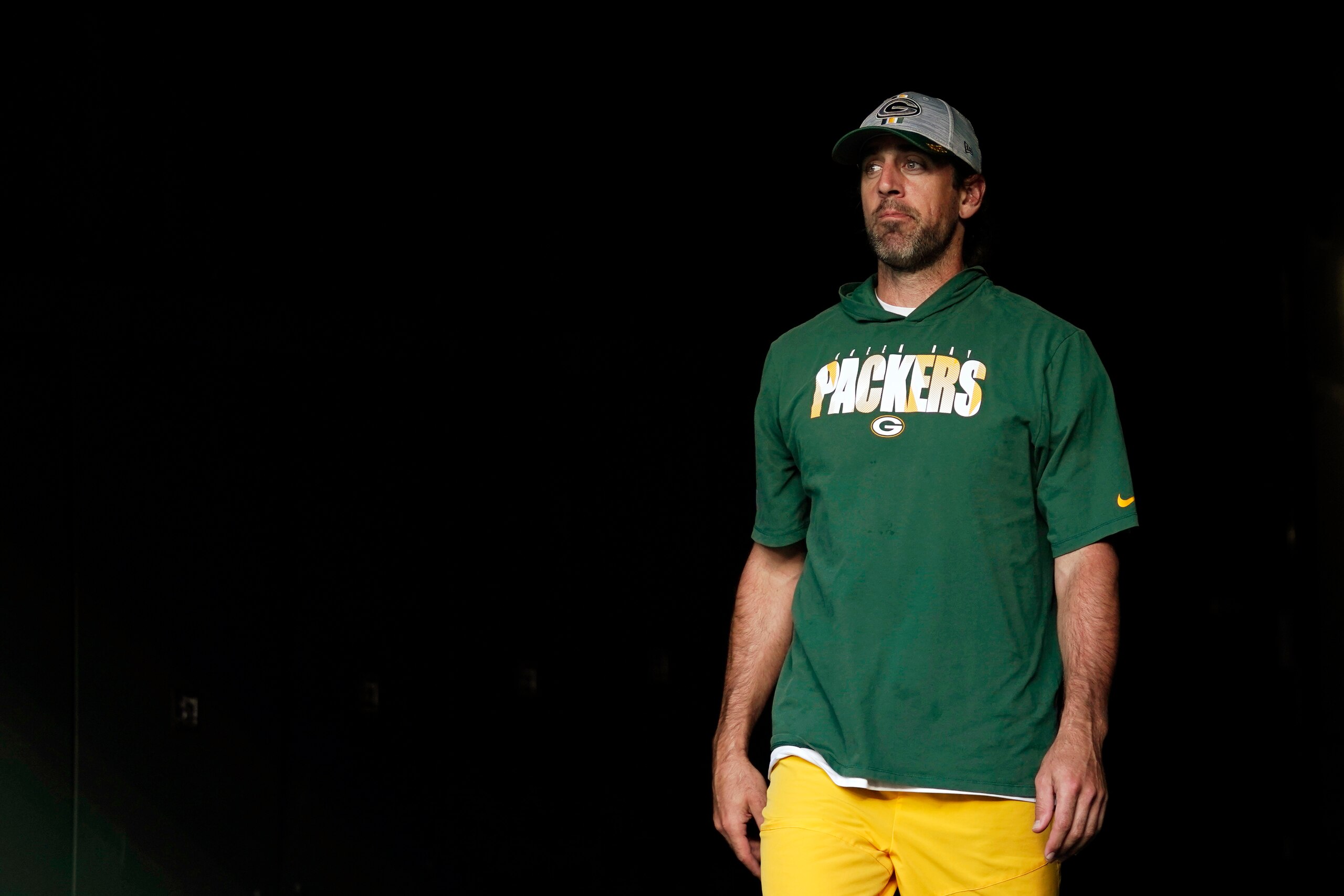 GREEN BAY, WISCONSIN - AUGUST 14: Aaron Rodgers #12 of the Green Bay Packers walks onto the field before a game against the Houston Texans during the preseason game at Lambeau Field on August 14, 2021 in Green Bay, Wisconsin. (Photo by Patrick McDermott/Getty Images)