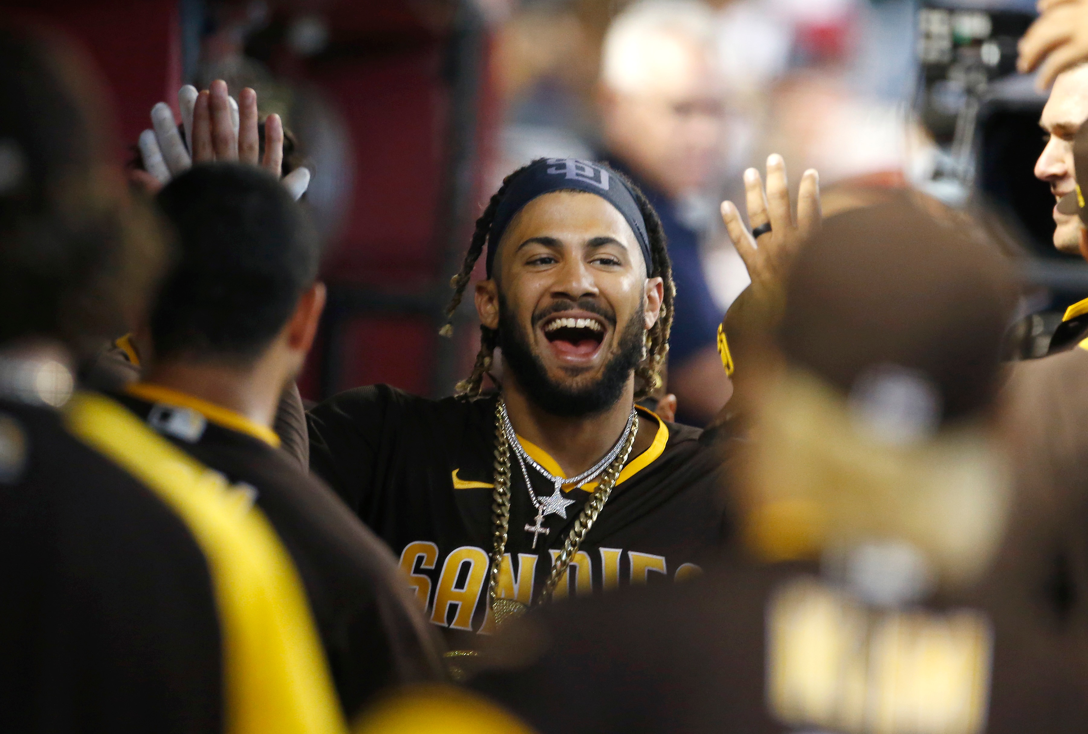 PHOENIX, ARIZONA - AUGUST 15: Fernando Tatis Jr #23 of the San Diego Padres is congratulated by teammates after hitting a solo home run against the Arizona Diamondbacks during the third inning of the MLB game at Chase Field on August 15, 2021 in Phoenix, Arizona. (Photo by Ralph Freso/Getty Images)