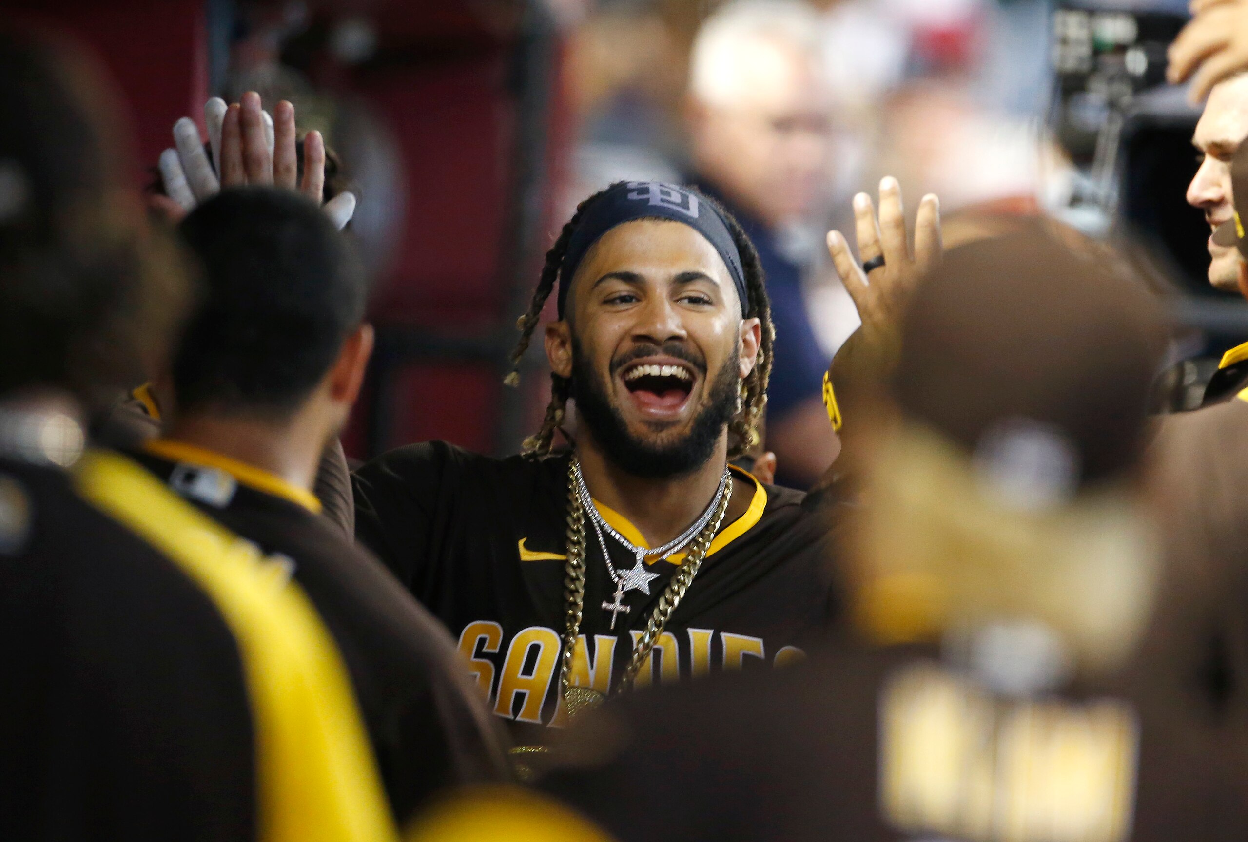 PHOENIX, ARIZONA - AUGUST 15: Fernando Tatis Jr #23 of the San Diego Padres is congratulated by teammates after hitting a solo home run against the Arizona Diamondbacks during the third inning of the MLB game at Chase Field on August 15, 2021 in Phoenix, Arizona. (Photo by Ralph Freso/Getty Images)