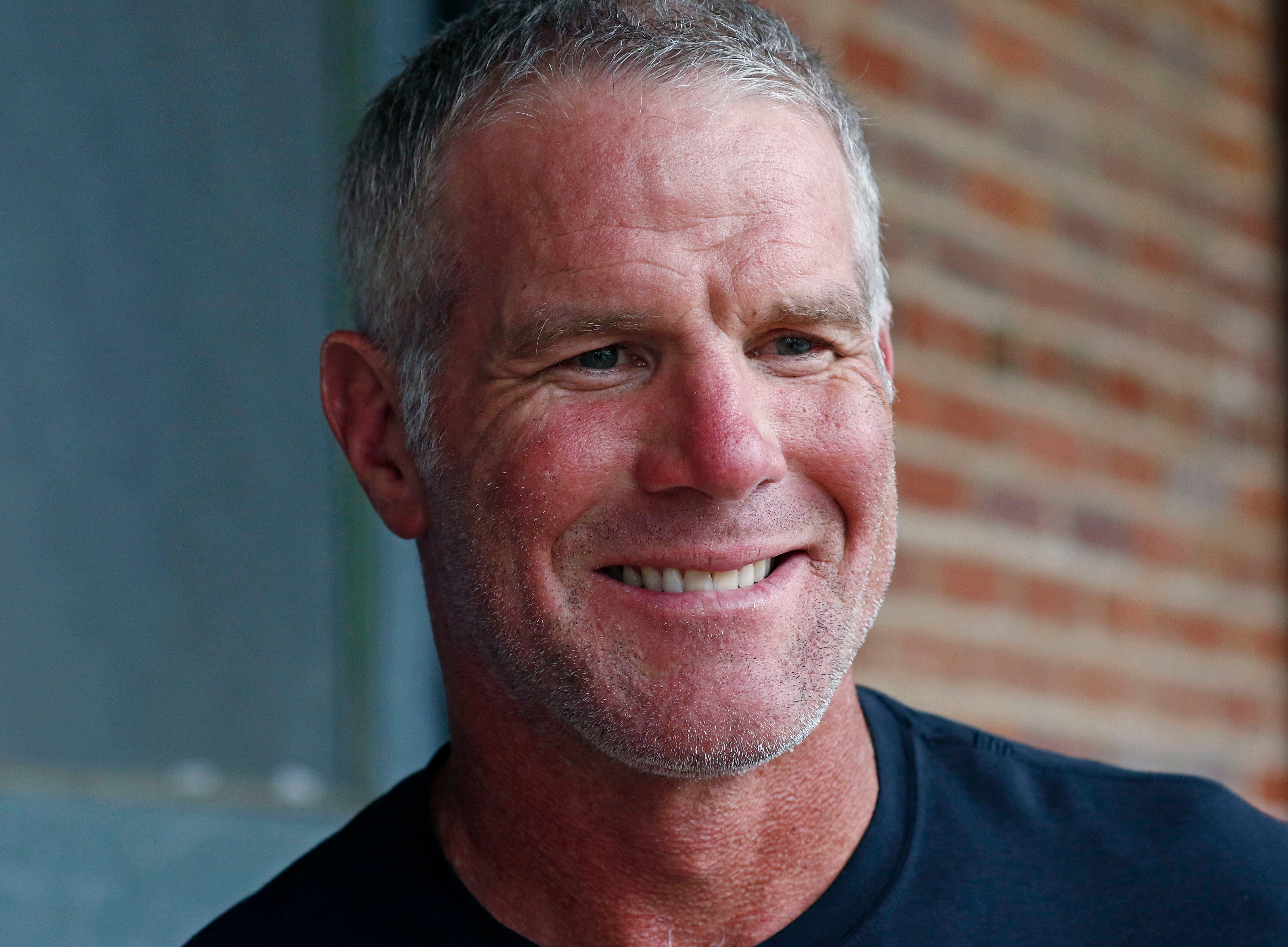 NFL Hall of Fame quarterback Brett Favre speaks with reporters about his support for Willowood Developmental Center, a facility that provides training and assistance for special needs students, Wednesday, Oct. 17, 2018 in Jackson, Miss. Favre, whose mother has a degree in special education, said he is a few hours short of graduating from Southern Mississippi and is being encouraged by his mother to obtain his degree. (AP Photo/Rogelio V. Solis)
