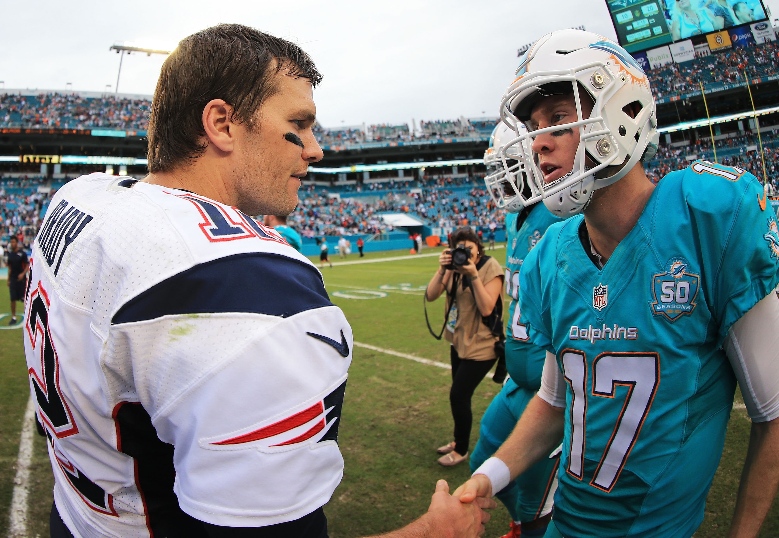 MIAMI GARDENS, FL - JANUARY 03: Tom Brady #12 of the New England Patriots and Ryan Tannehill #17 of the Miami Dolphins shake hands after the game at Sun Life Stadium on January 3, 2016 in Miami Gardens, Florida. (Photo by Mike Ehrmann/Getty Images)