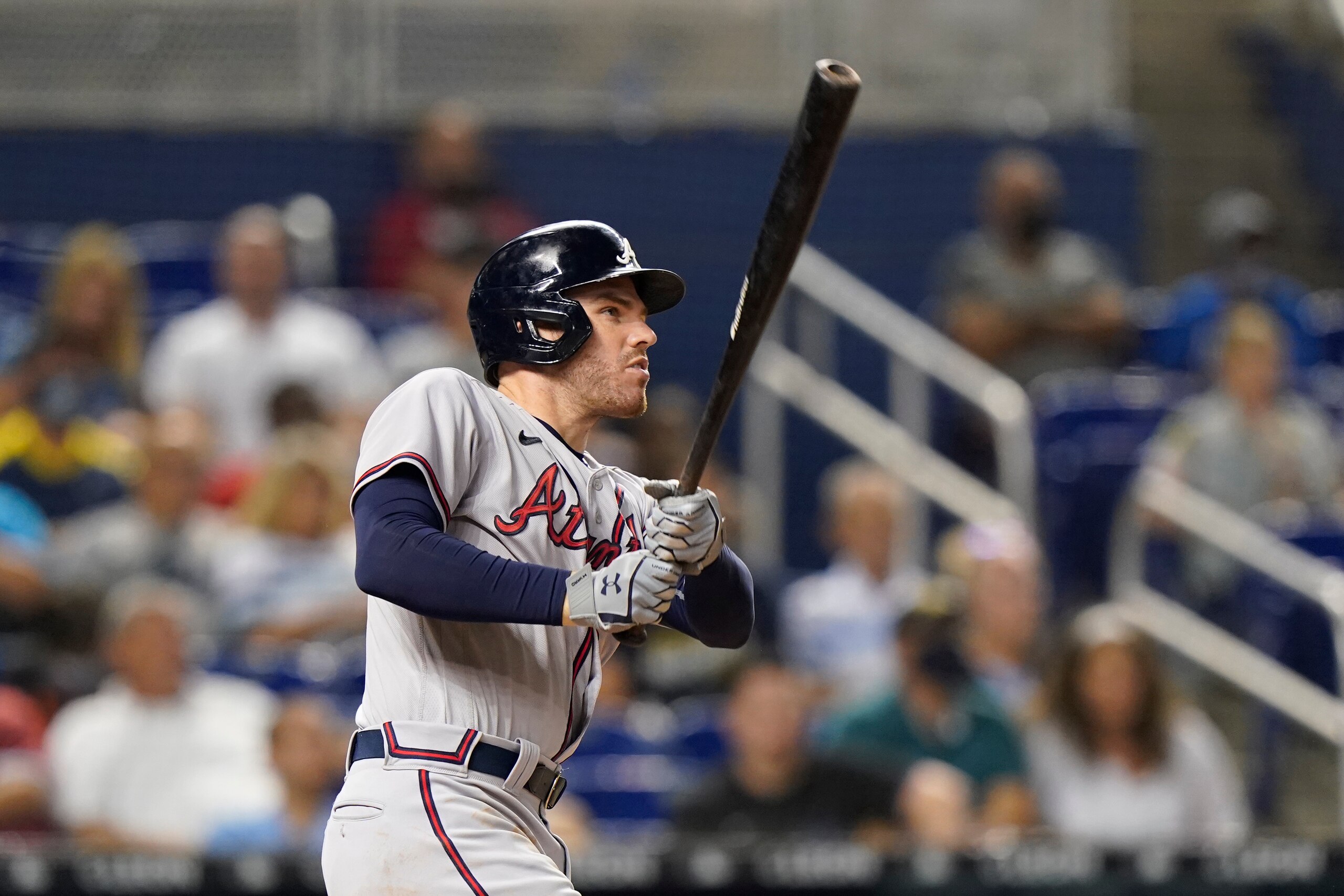 Atlanta Braves' Freddie Freeman watches the ball after hitting a home run, scoring Ozzie Albies and Touki Toussaint during the fourth inning of a baseball game against the Miami Marlins, Monday, Aug. 16, 2021, in Miami. (AP Photo/Wilfredo Lee)