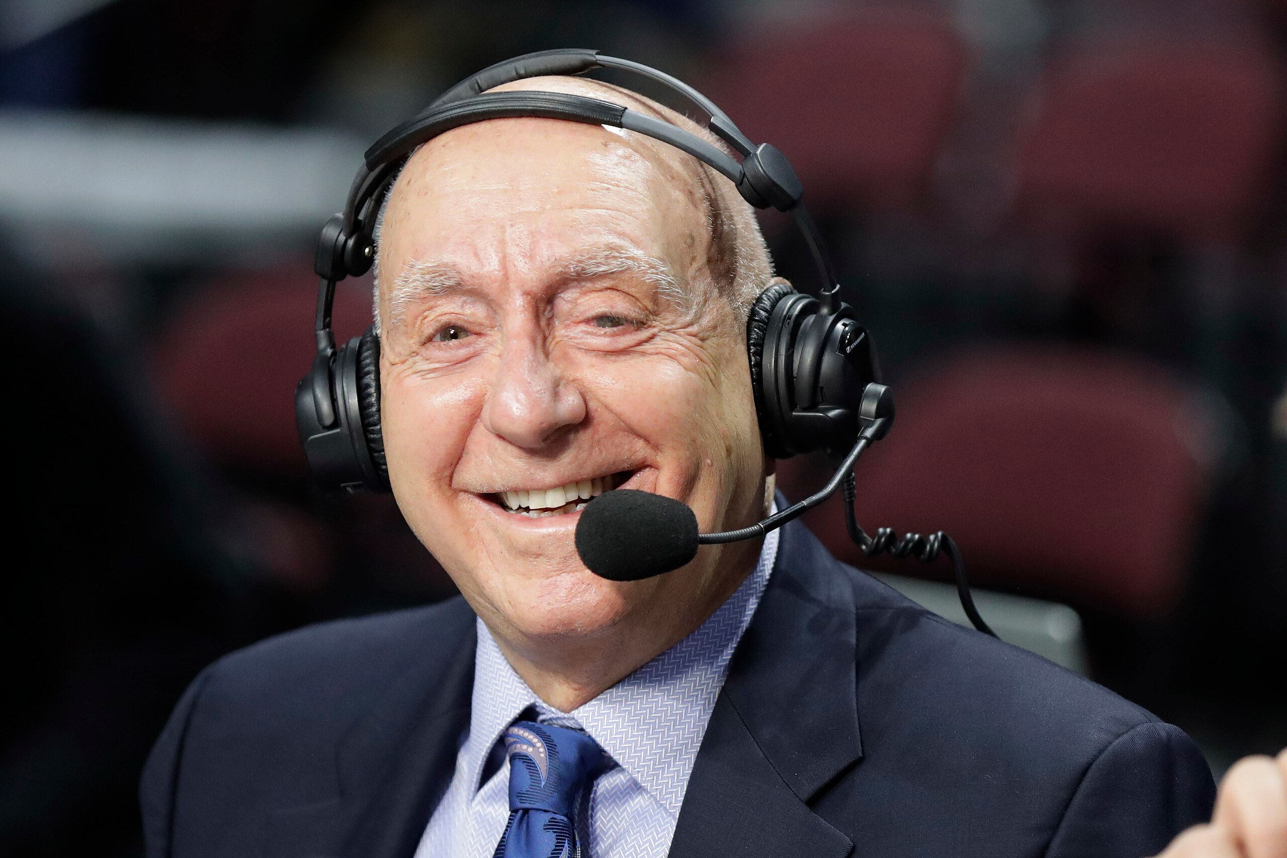 Sportscaster Dick Vitale broadcasts before an NCAA college basketball game in the West Coast Conference men's tournament Monday, March 9, 2020, in Las Vegas. (AP Photo/Isaac Brekken)