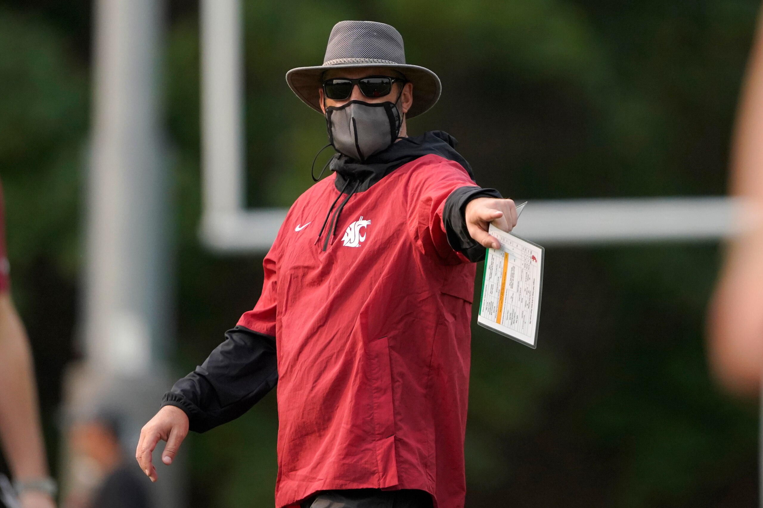 Washington State head coach Nick Rolovich wears a mask as he gives directions during the first day of NCAA college football practice, Friday, Aug. 6, 2021, in Pullman, Wash. (AP Photo/Ted S. Warren)