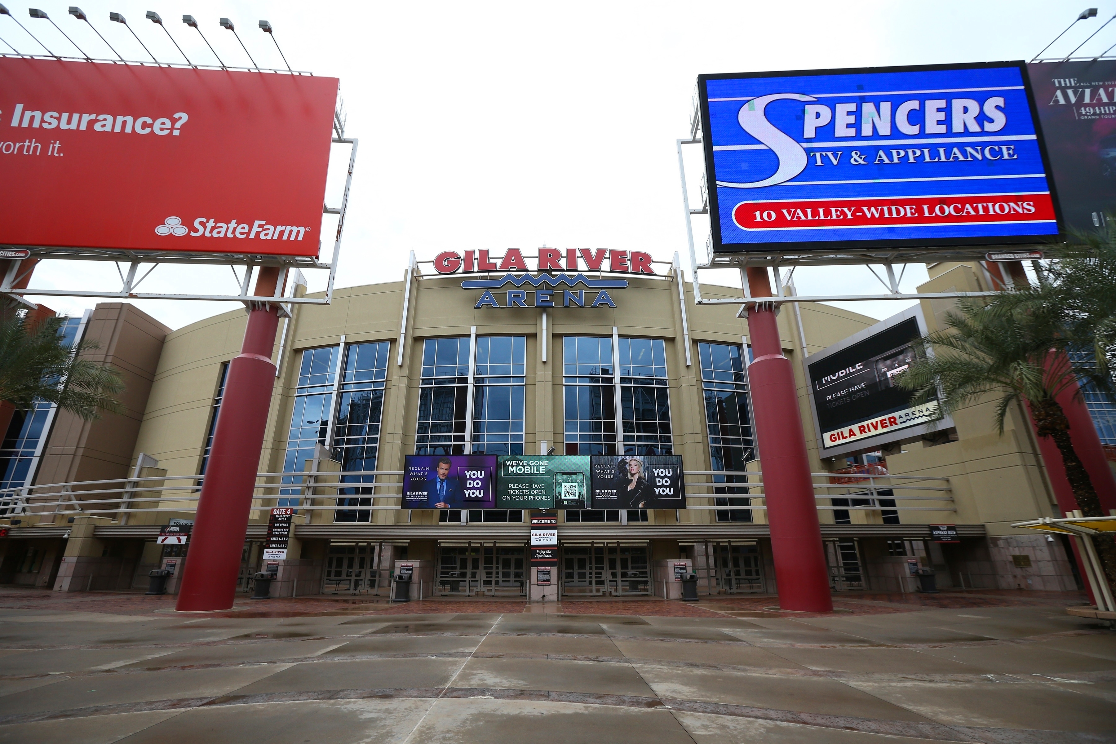 The Gila River Arena, home of the Arizona Coyotes NHL hockey club, is closed as the Coyotes' scheduled game with the Vancouver Canucks was canceled Thursday, March 12, 2020, in Glendale, Ariz. The NHL is following the NBA's lead and suspending its season amid the coronavirus outbreak, the league announced Thursday. (AP Photo/Ross D. Franklin)