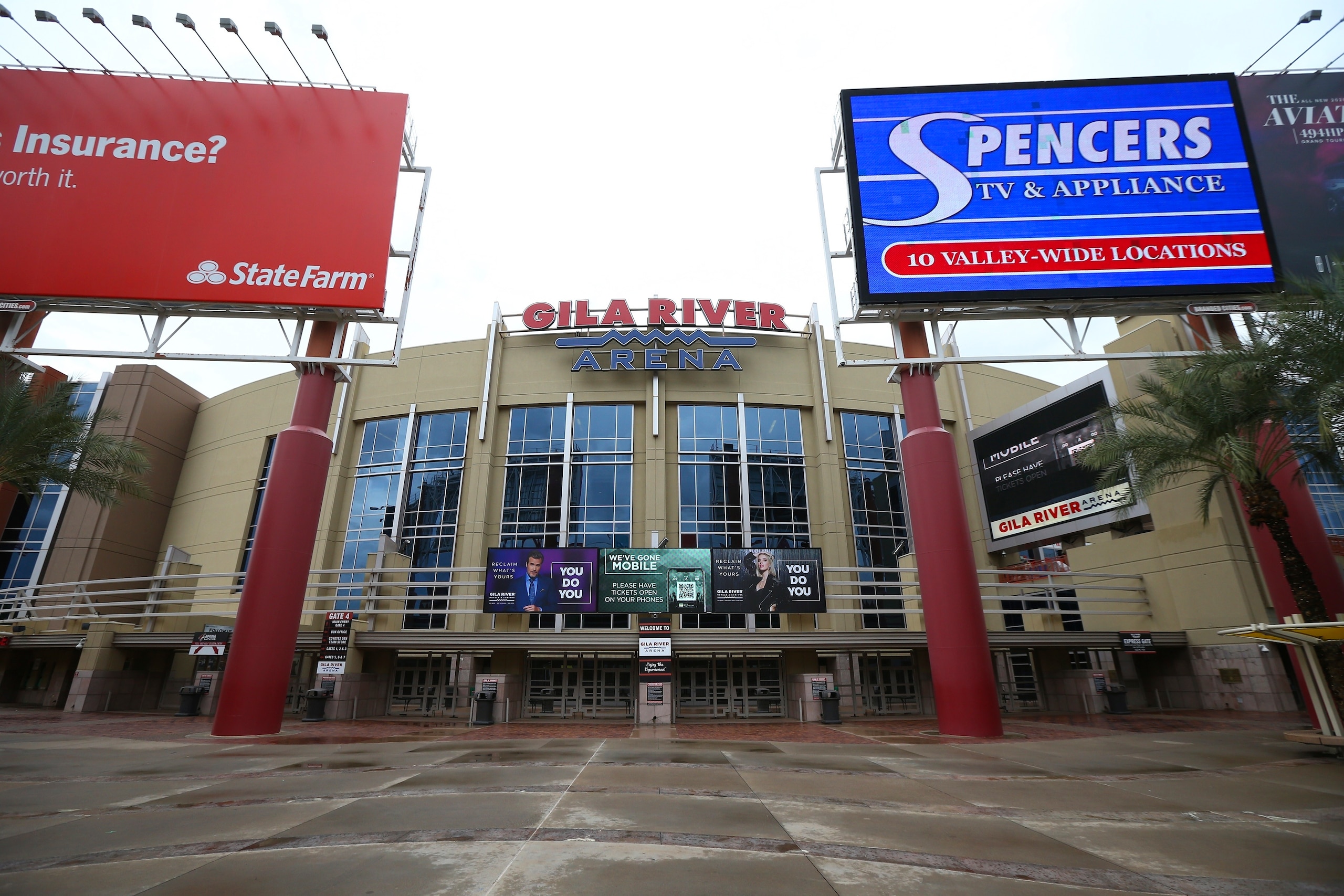 The Gila River Arena, home of the Arizona Coyotes NHL hockey club, is closed as the Coyotes' scheduled game with the Vancouver Canucks was canceled Thursday, March 12, 2020, in Glendale, Ariz. The NHL is following the NBA's lead and suspending its season amid the coronavirus outbreak, the league announced Thursday. (AP Photo/Ross D. Franklin)