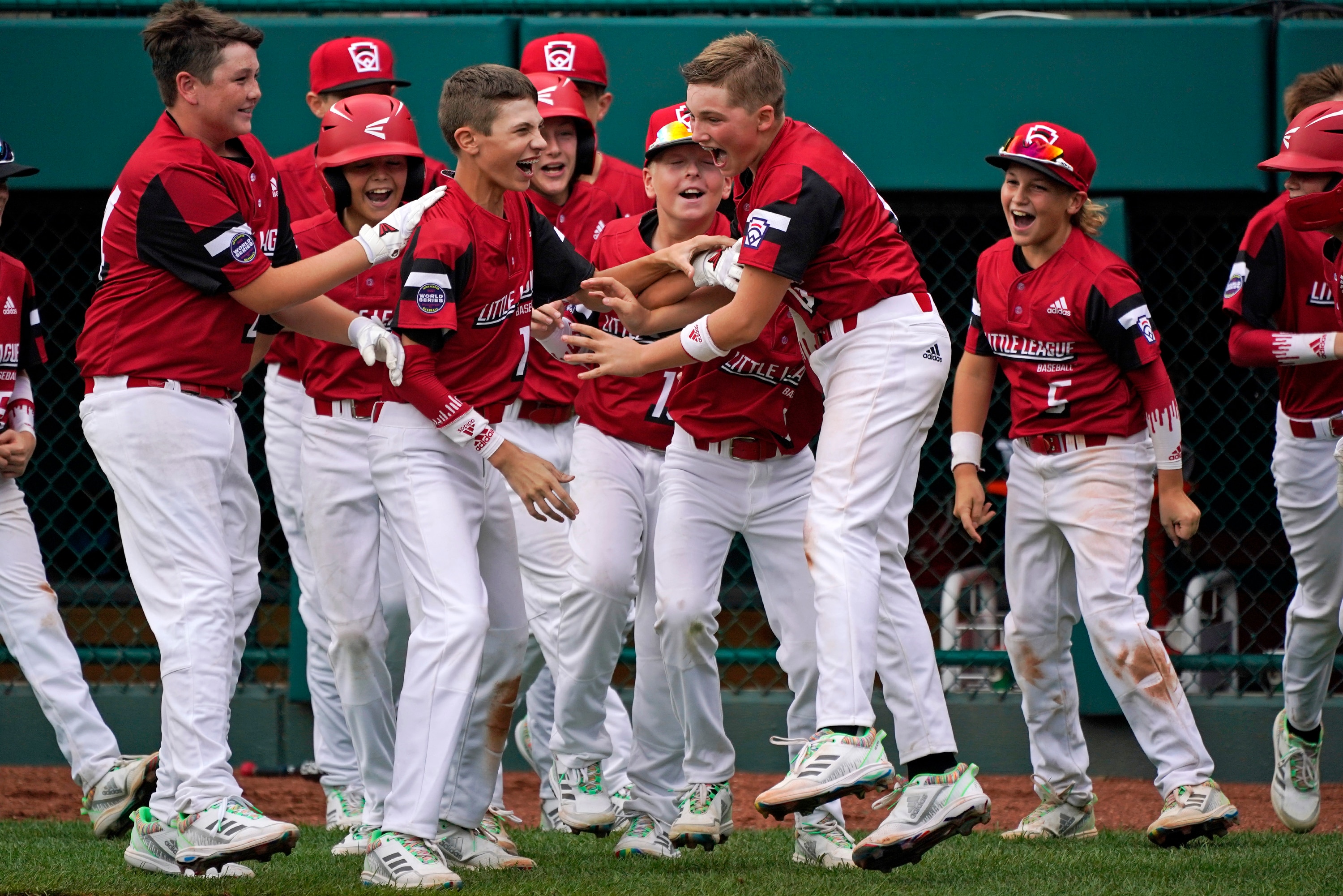 Hamilton, Ohio's Noah Davidson, center, celebrates with teammates after driving in the game-winning run in the eighth inning of a baseball game against Nolensville, Tenn., at the Little League World Series tournament in South Williamsport, Pa., Thursday, Aug. 19, 2021. Ohio won 1-0. (AP Photo/Gene J. Puskar)