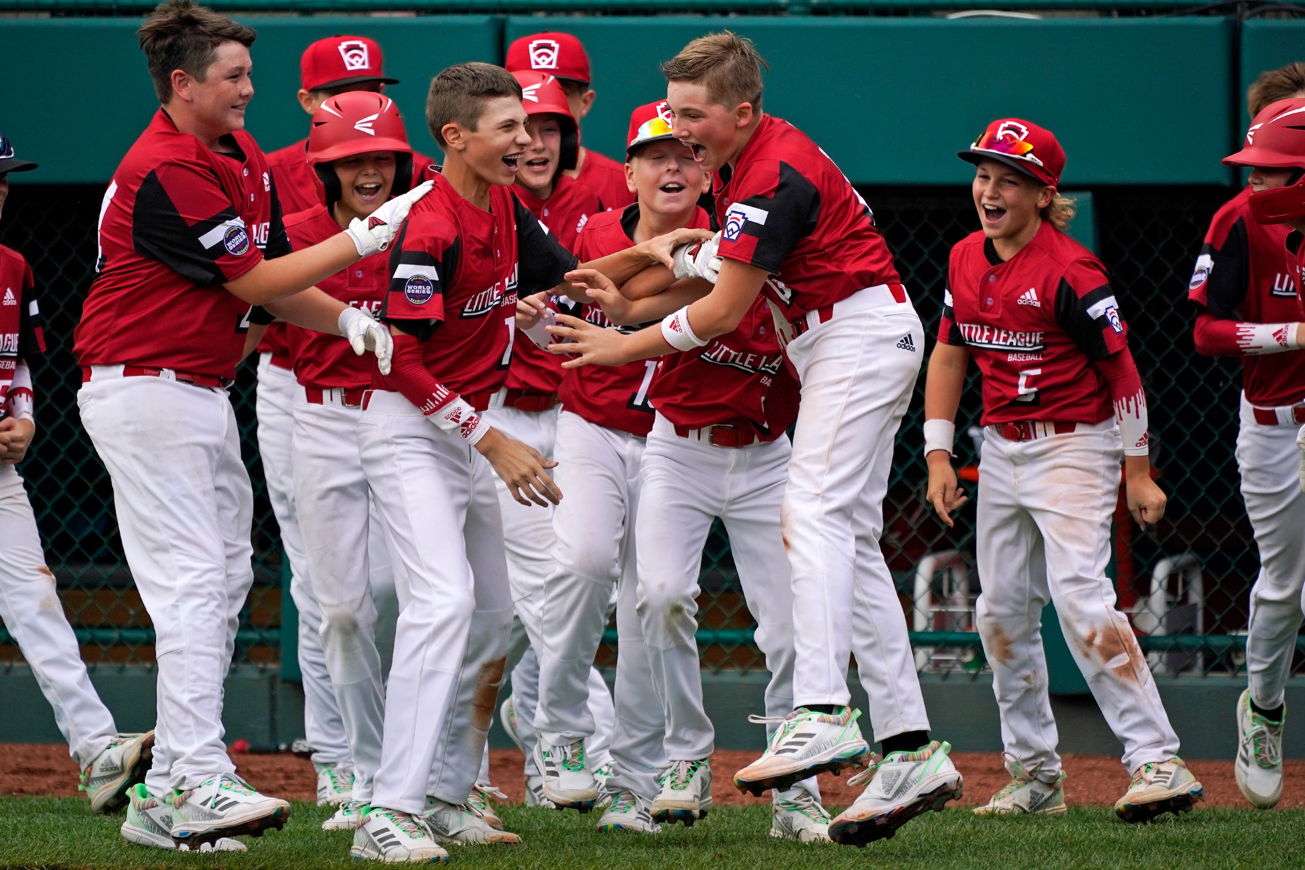 Hamilton, Ohio's Noah Davidson, center, celebrates with teammates after driving in the game-winning run in the eighth inning of a baseball game against Nolensville, Tenn., at the Little League World Series tournament in South Williamsport, Pa., Thursday, Aug. 19, 2021. Ohio won 1-0. (AP Photo/Gene J. Puskar)