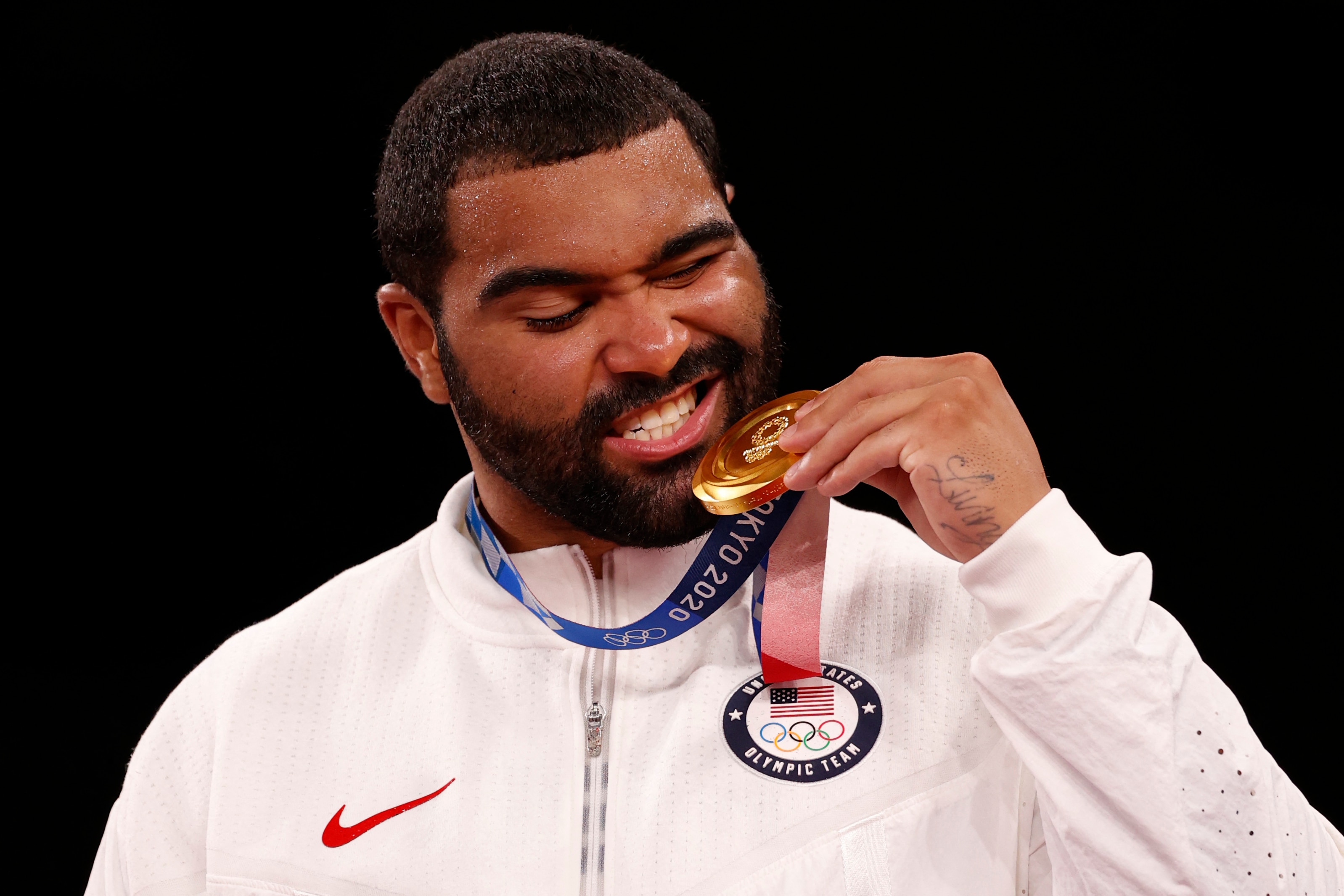 Gold medalist USA's Gable Dan Steveson poses with his medal on the podium after the men's freestyle 125kg wrestling competition during the Tokyo 2020 Olympic Games at the Makuhari Messe in Tokyo on August 6, 2021. (Photo by Jack GUEZ / AFP) (Photo by JACK GUEZ/AFP via Getty Images)