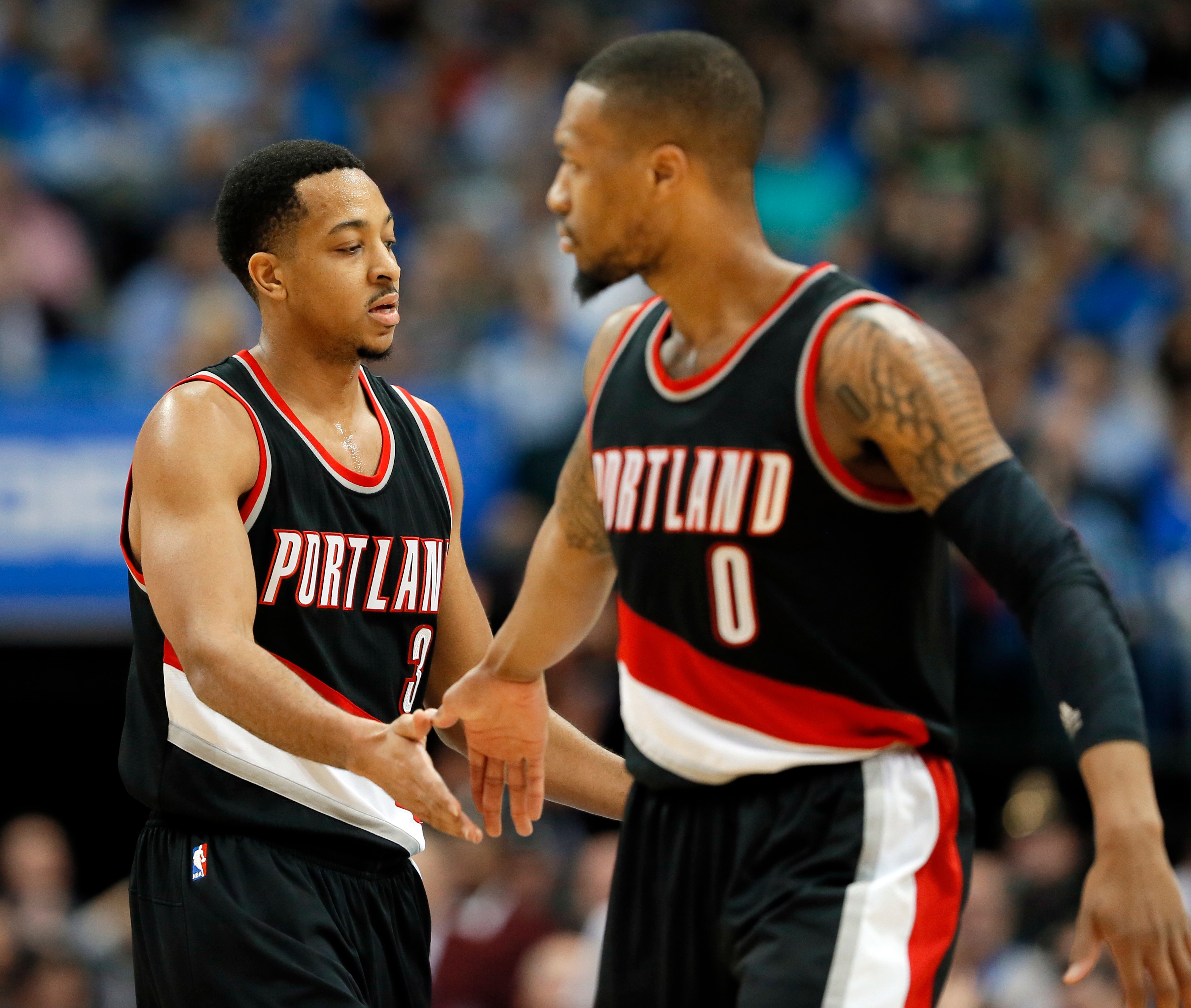 Portland Trail Blazers' C.J. McCollum (3) and Damian Lillard (0) celebrate a basket by McCollum against the Dallas Mavericks during the second half of an NBA basketball game in Dallas, Tuesday, Feb. 7, 2017. McCollum had 32 points and Lillard had 29 in the team's 114-113 win. (AP Photo/Tony Gutierrez)