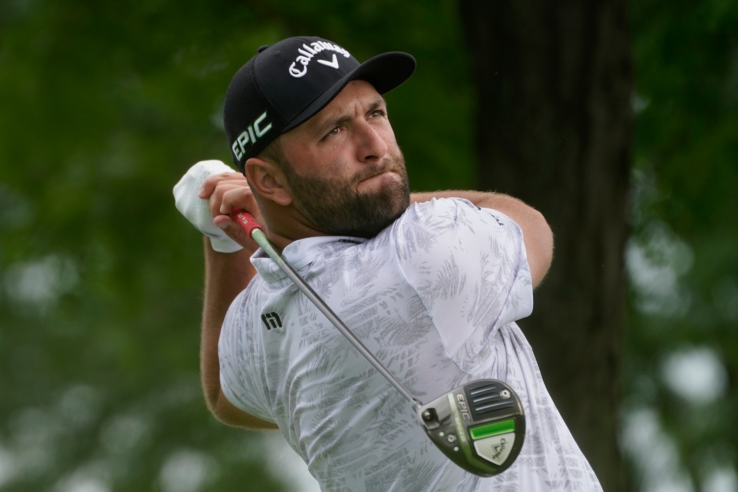 Jon Rahm, of Spain, watches his shot off the 13th tee in the second round at the Northern Trust golf tournament, Friday, Aug. 20, 2021, at Liberty National Golf Course in Jersey City, N.J. (AP Photo/John Minchillo)