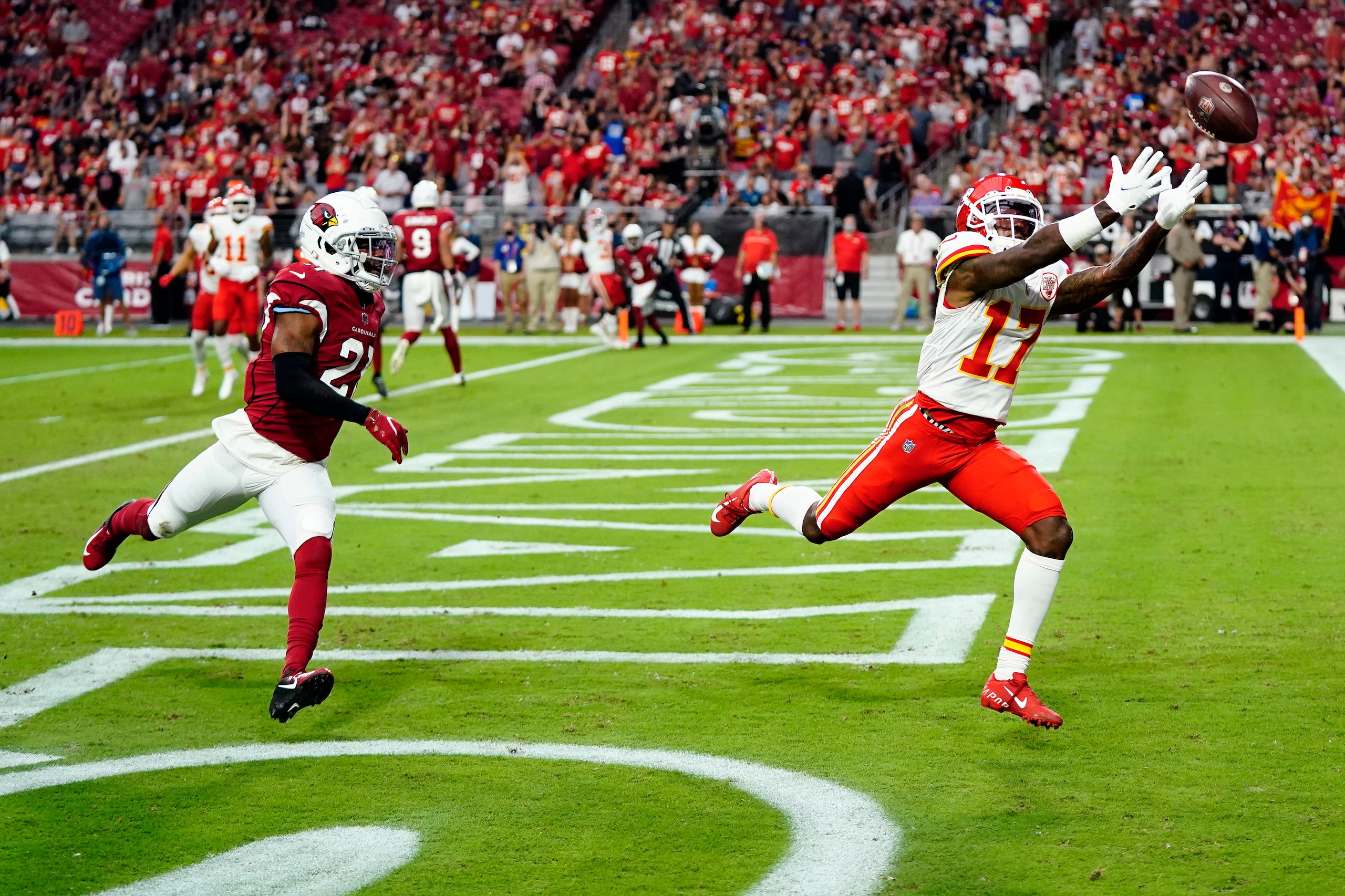 Kansas City Chiefs wide receiver Mecole Hardman (17) can't make the catch as Arizona Cardinals cornerback Malcolm Butler (21) defends during the first half of an NFL football game, Friday, Aug. 20, 2021, in Glendale, Ariz. (AP Photo/Ross D. Franklin)