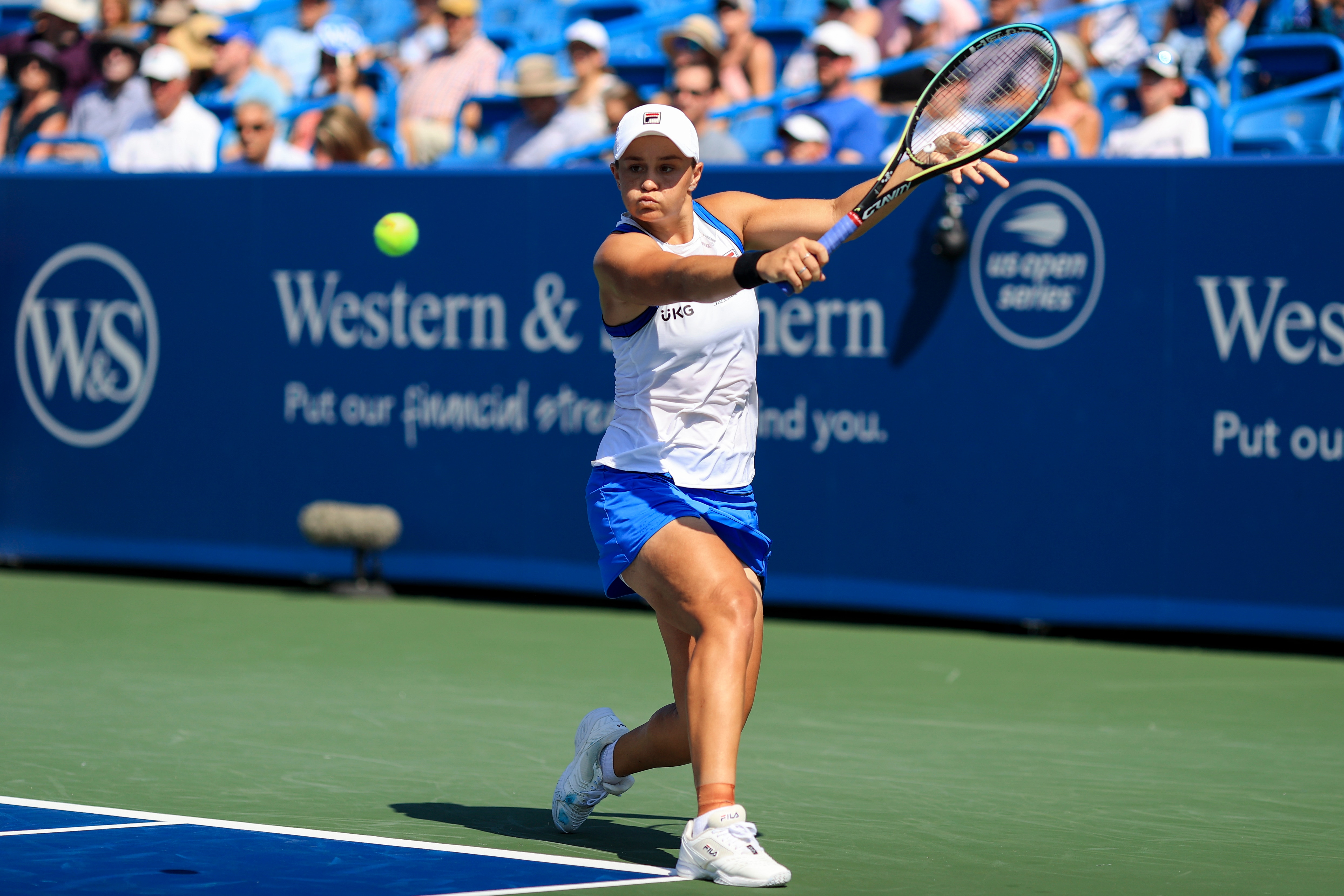 Ashleigh Barty, of Australia, returns to Angelique Kerber, of Germany, during the Western & Southern Open tennis tournament Saturday, Aug. 21, 2021, in Mason, Ohio. (AP Photo/Aaron Doster)
