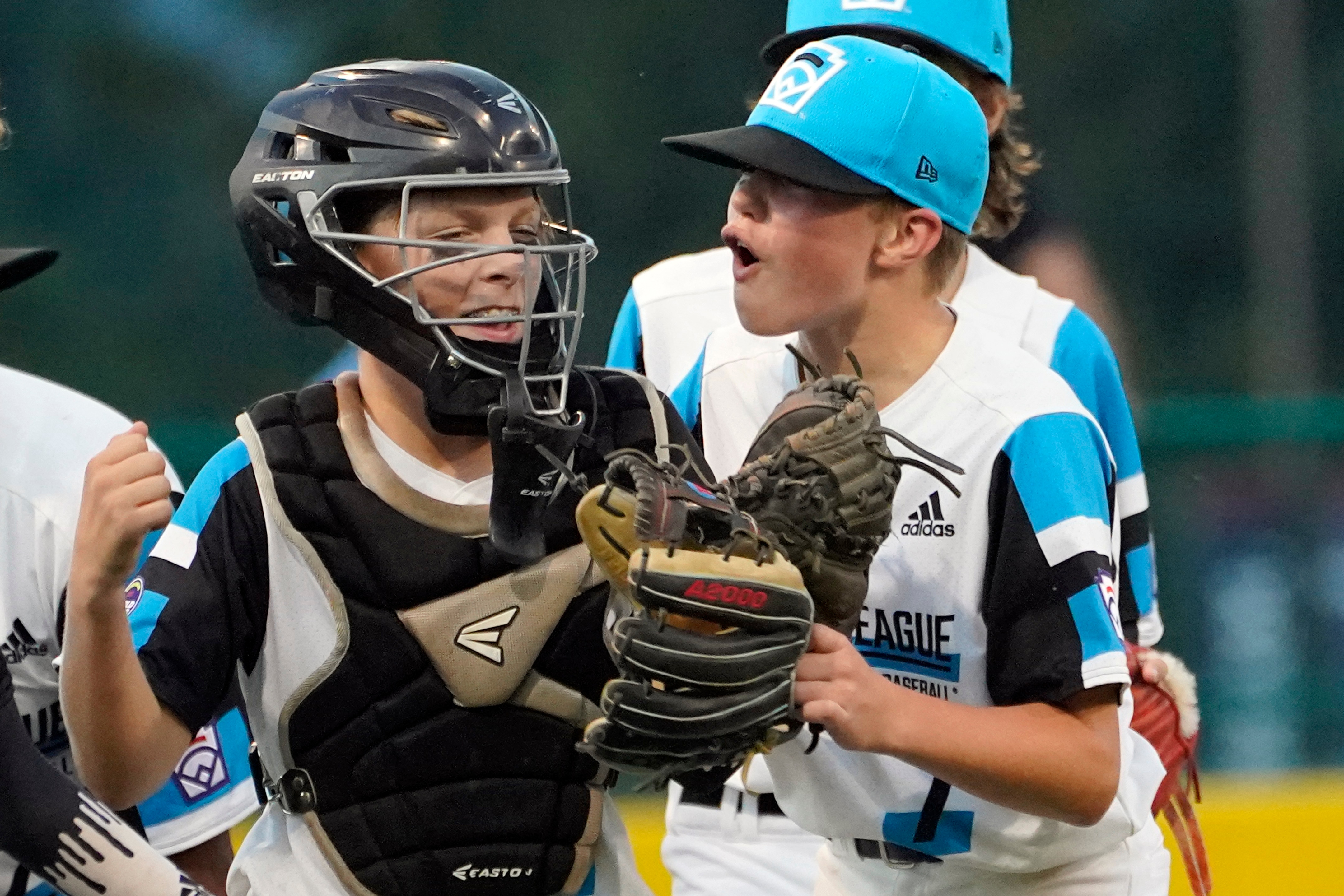 Sammamish, Wash., pitcher Eli Jones, right, celebrates with catcher Jackson Wheeler after the final out in the win over Palm City, Fla., during a baseball game at the Little League World Series in South Williamsport, Pa., Saturday, Aug. 21, 2021. Jones threw a no-hitter in the game. (AP Photo/Tom E. Puskar)