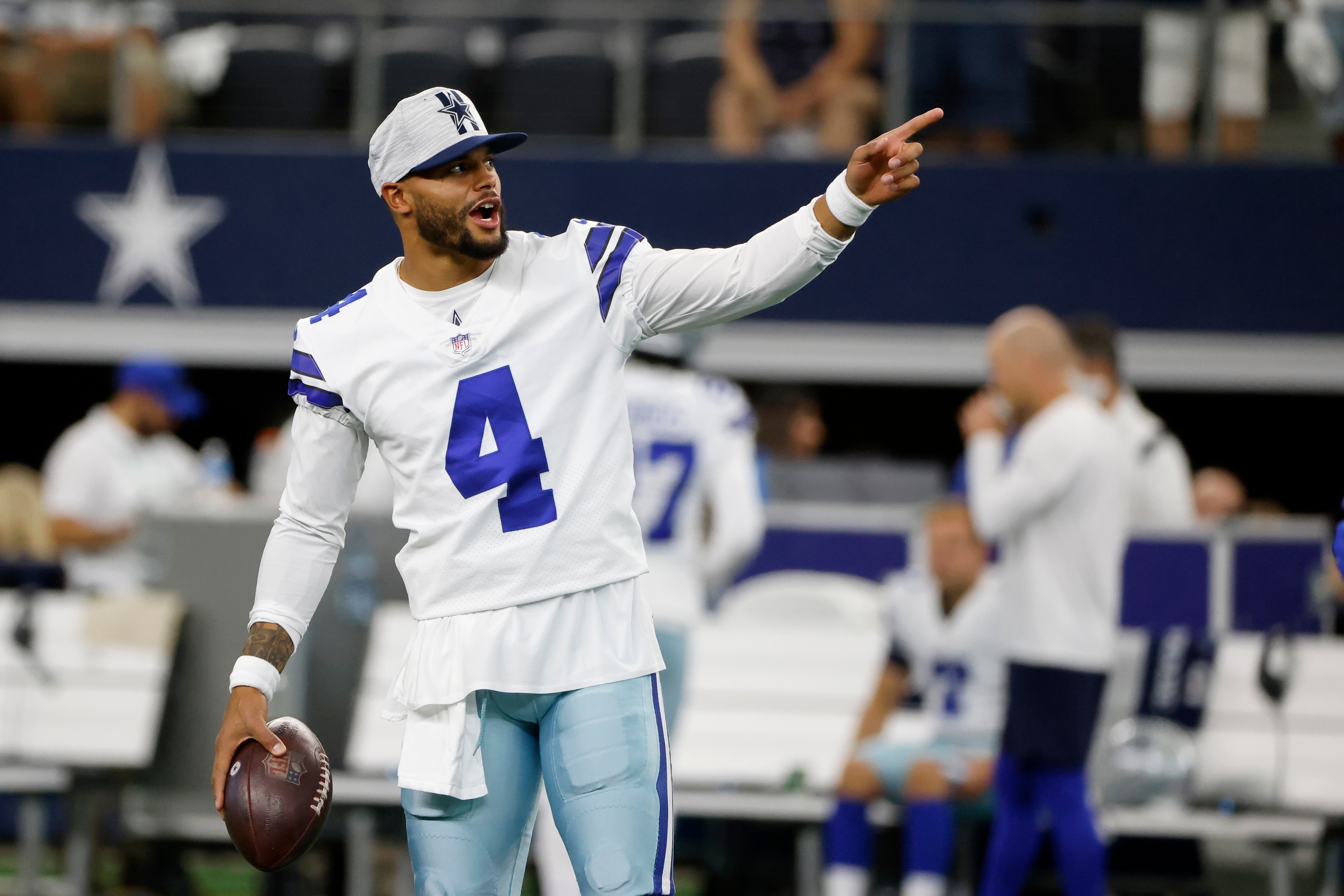 Dallas Cowboys' Dak Prescott gestures as he stands on the field during warmups before a preseason NFL football game against the Houston Texans in Arlington, Texas, Saturday, Aug. 21, 2021. (AP Photo/Michael Ainsworth)