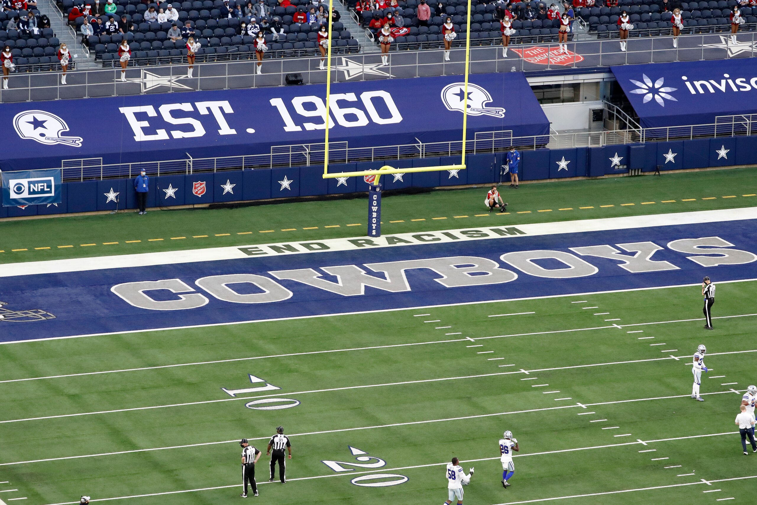 End Racism and the Dallas Cowboys logo are displayed on the end zone during an NFL football game between the Dallas Cowboys and the San Francisco 49ers in Arlington, Texas, Sunday, Dec. 20, 2020. (AP Photo/Roger Steinman)